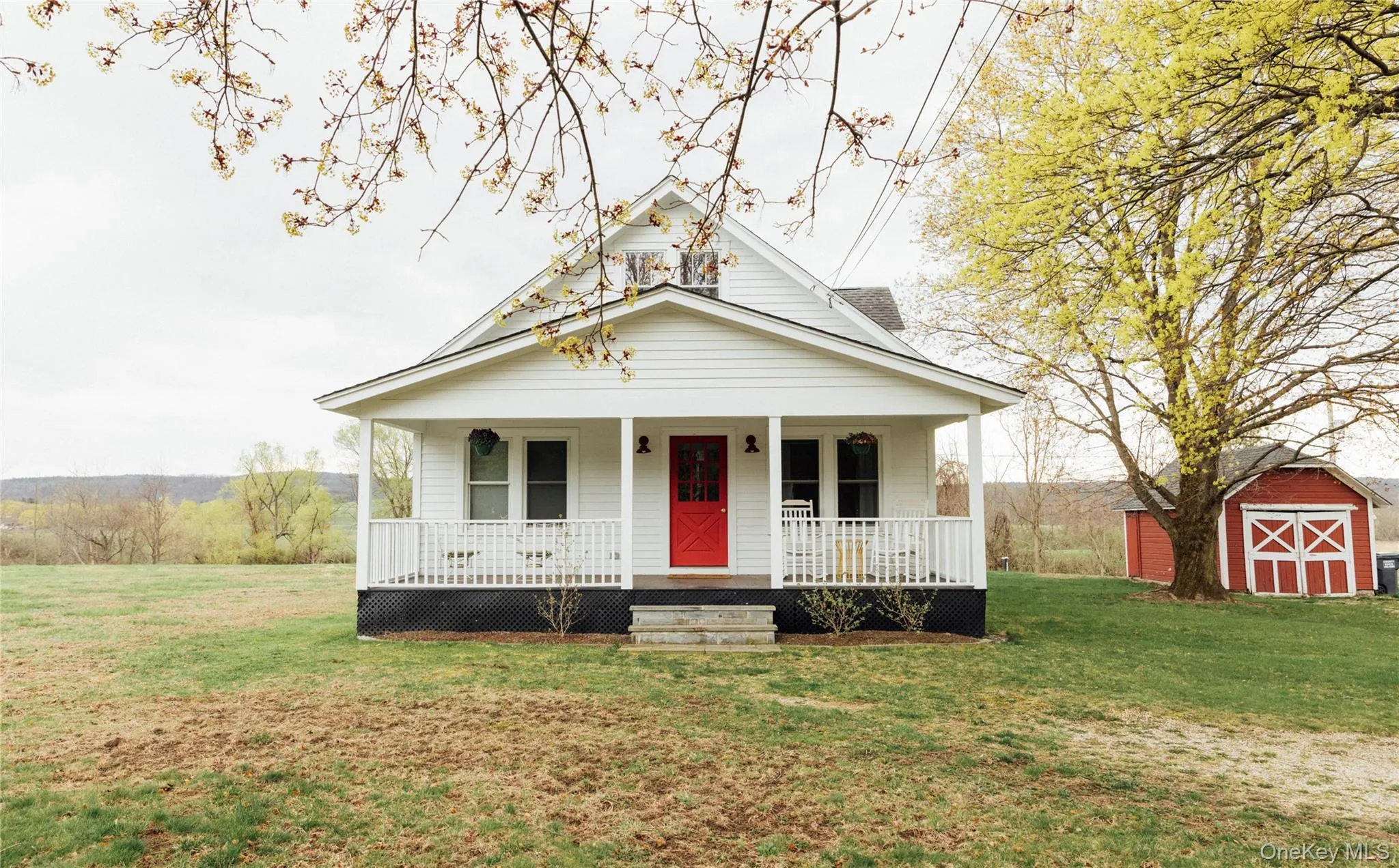 Bungalow-style house featuring covered porch, a storage shed, an outdoor structure, and a front yard Bungalow-style house featuring covered porch, a storage shed, an outdoor structure, and a front yard