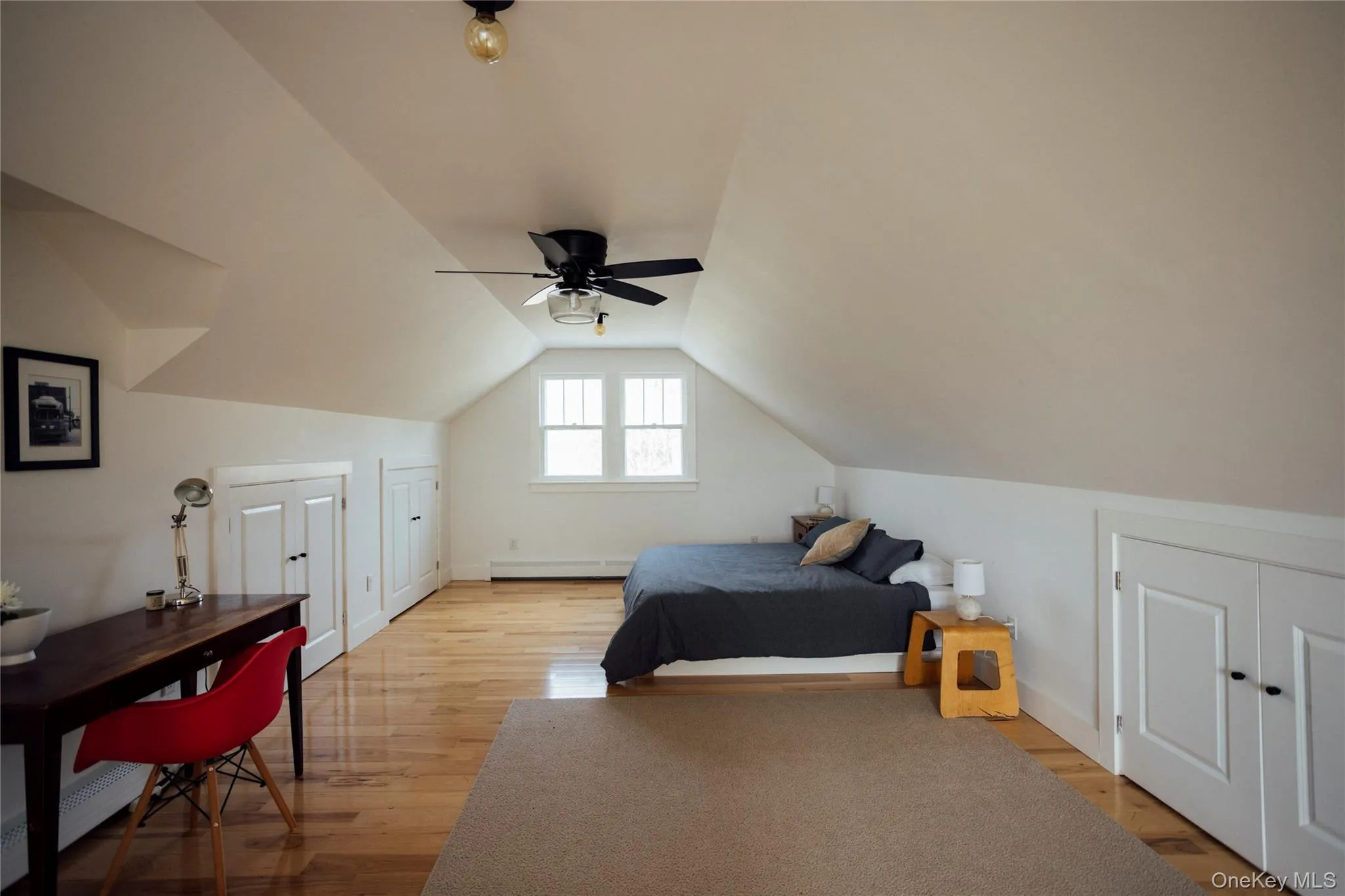 Bedroom with ceiling fan, baseboard heating, light wood-style flooring, baseboards, and lofted ceiling Bedroom with ceiling fan, baseboard heating, light wood-style flooring, baseboards, and lofted ceiling