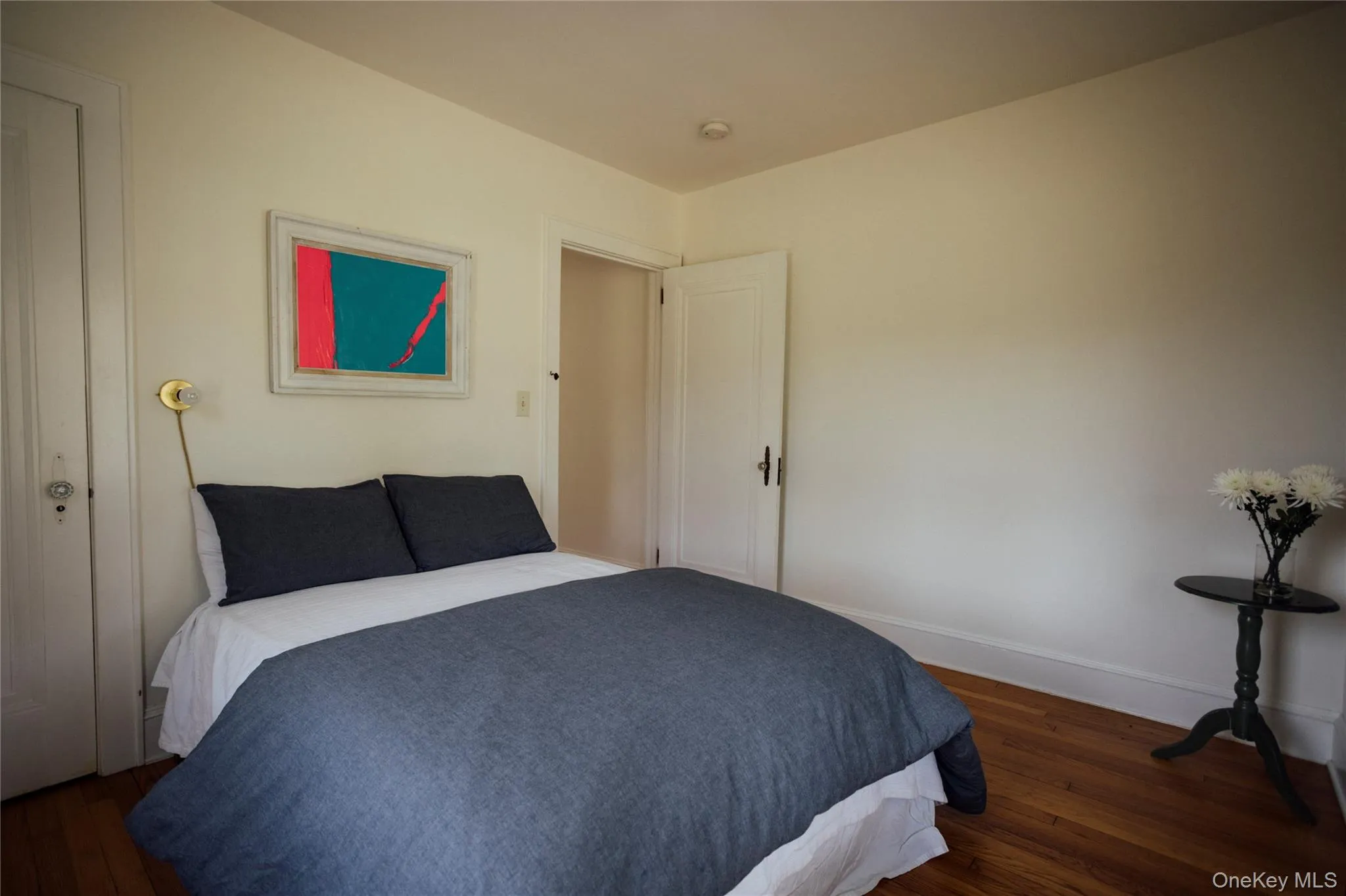 Bedroom with baseboards and wood finished floors Bedroom with baseboards and wood finished floors