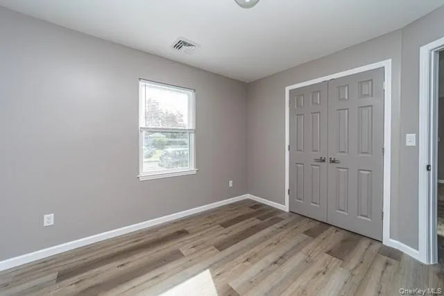 Unfurnished bedroom with a closet and light wood-style floors Unfurnished bedroom with a closet and light wood-style floors