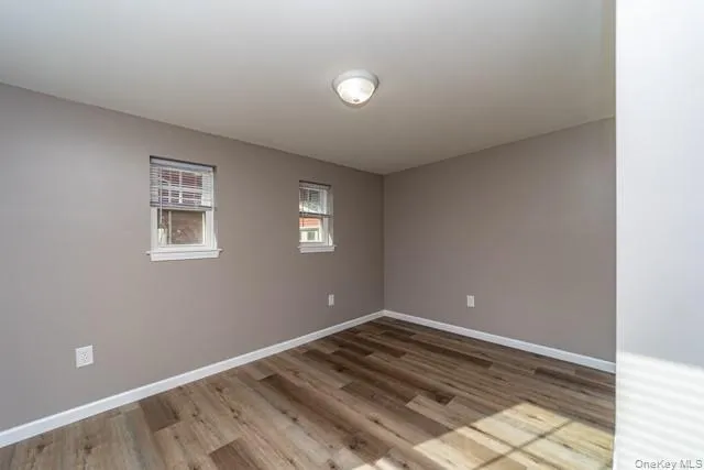 Unfurnished room featuring baseboards and light wood-style flooring Unfurnished room featuring baseboards and light wood-style flooring