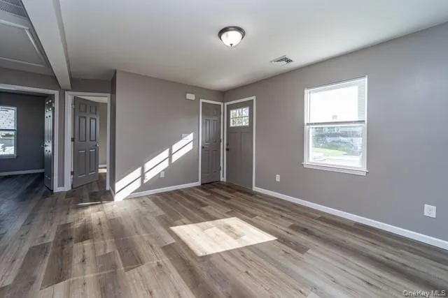Entrance foyer with light wood-style floors and baseboards Entrance foyer with light wood-style floors and baseboards