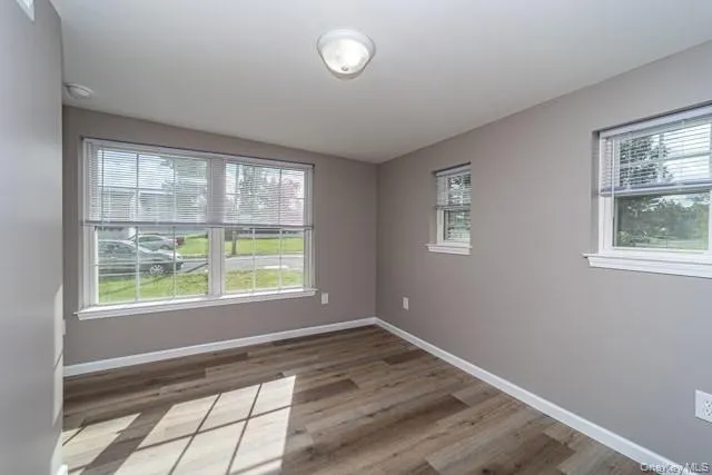 Spare room featuring baseboards and light wood-style flooring Spare room featuring baseboards and light wood-style flooring