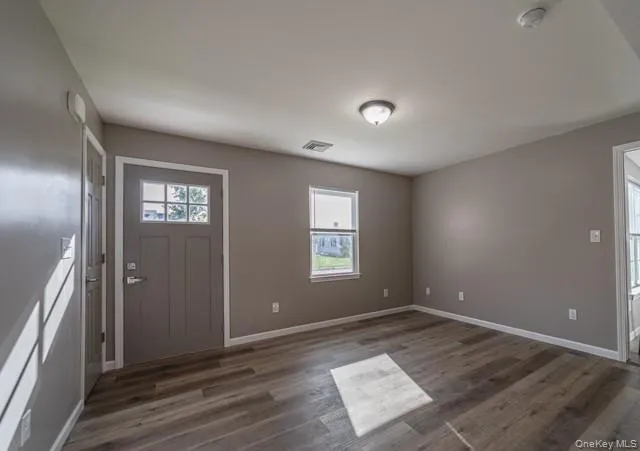 Foyer with dark wood finished floors and baseboards Foyer with dark wood finished floors and baseboards