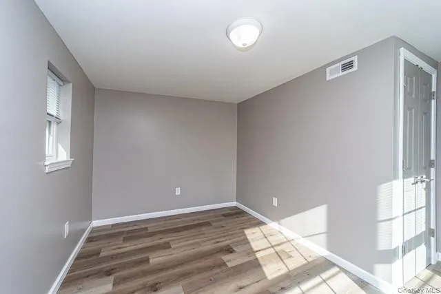 Unfurnished room featuring baseboards and light wood-style flooring Unfurnished room featuring baseboards and light wood-style flooring