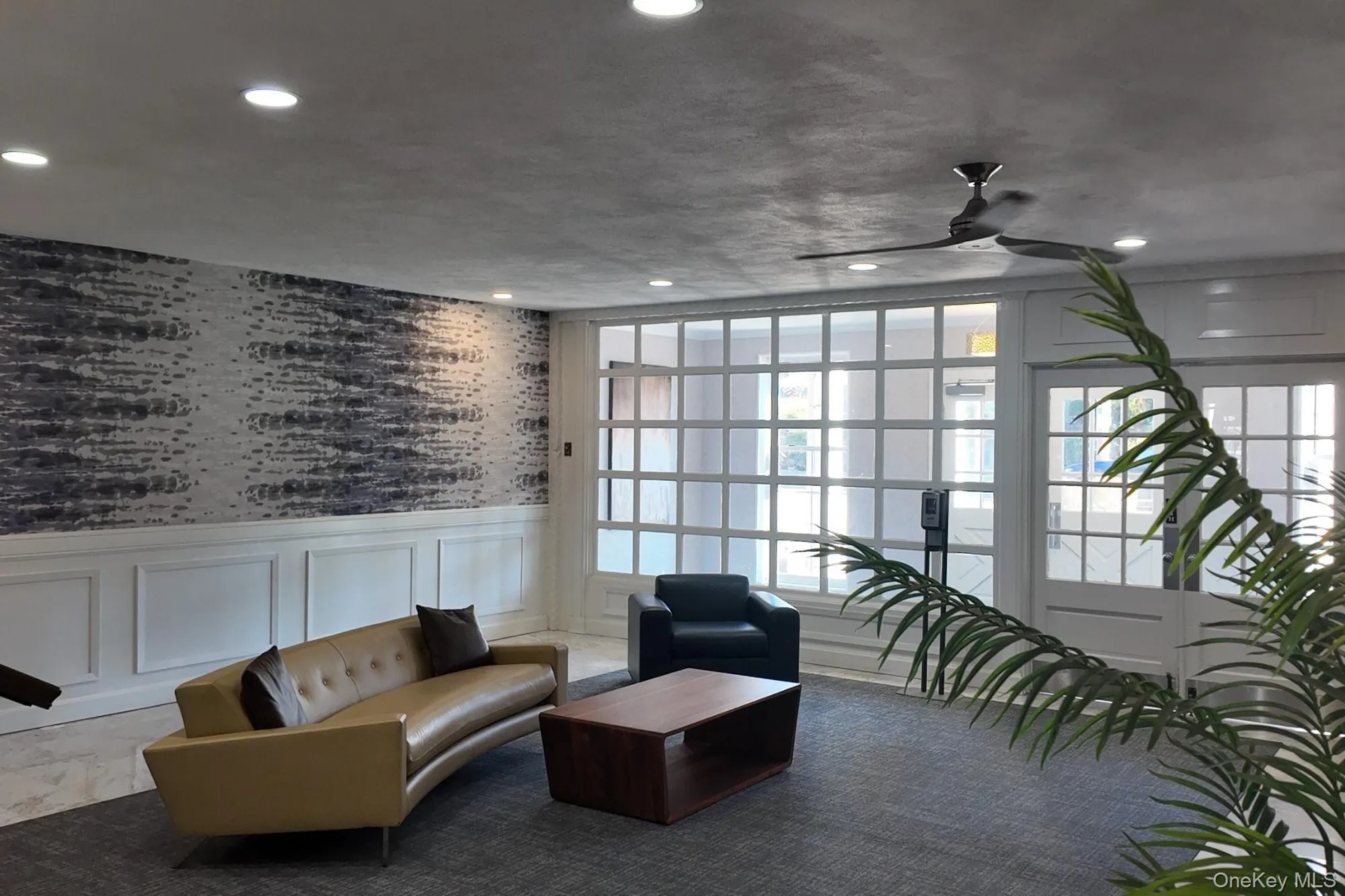 Lobby featuring wainscoting, a decorative wall, wallpapered walls, and recessed lighting Lobby featuring wainscoting, a decorative wall, wallpapered walls, and recessed lighting