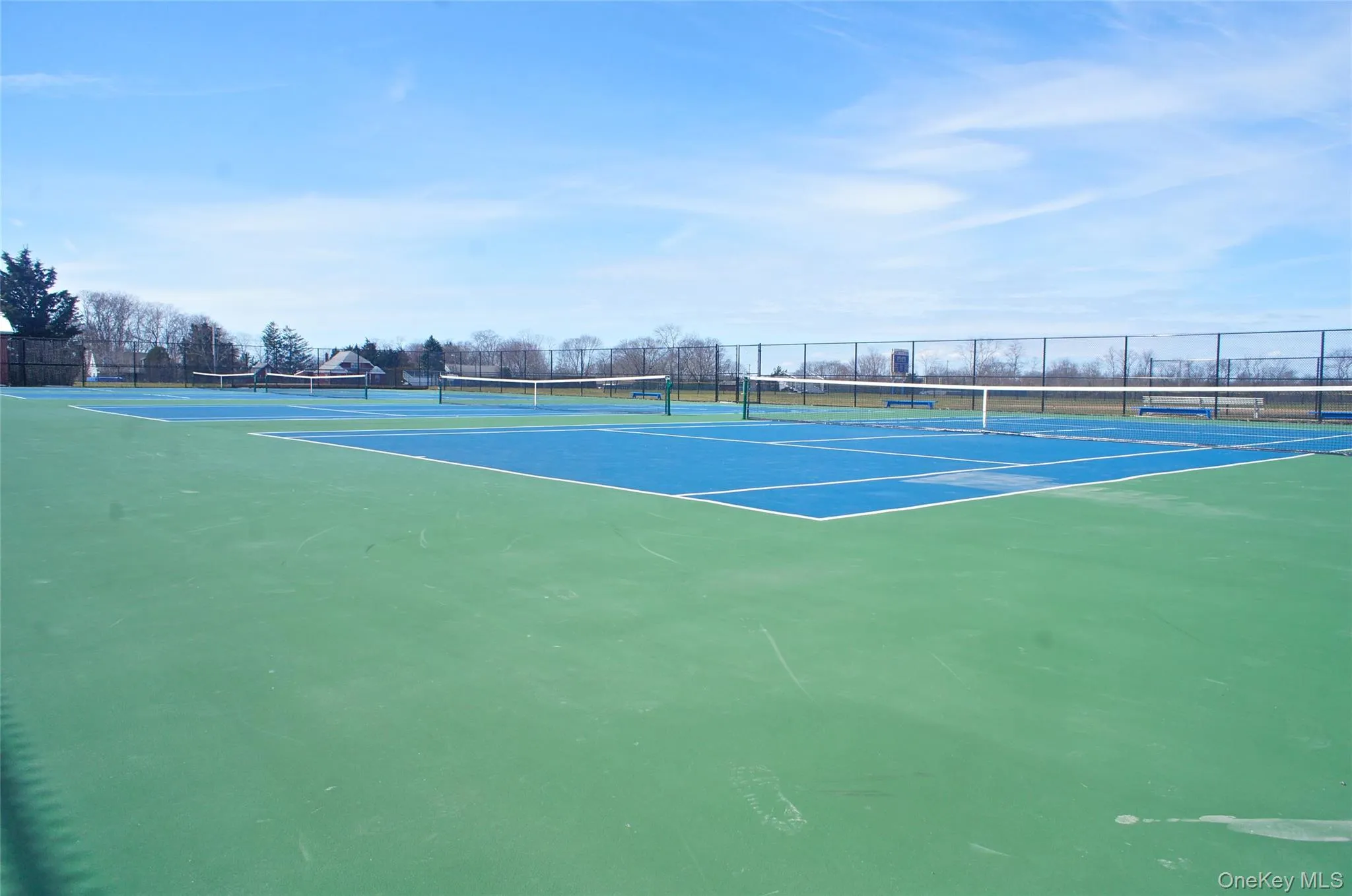 View of tennis court with community basketball court View of tennis court with community basketball court