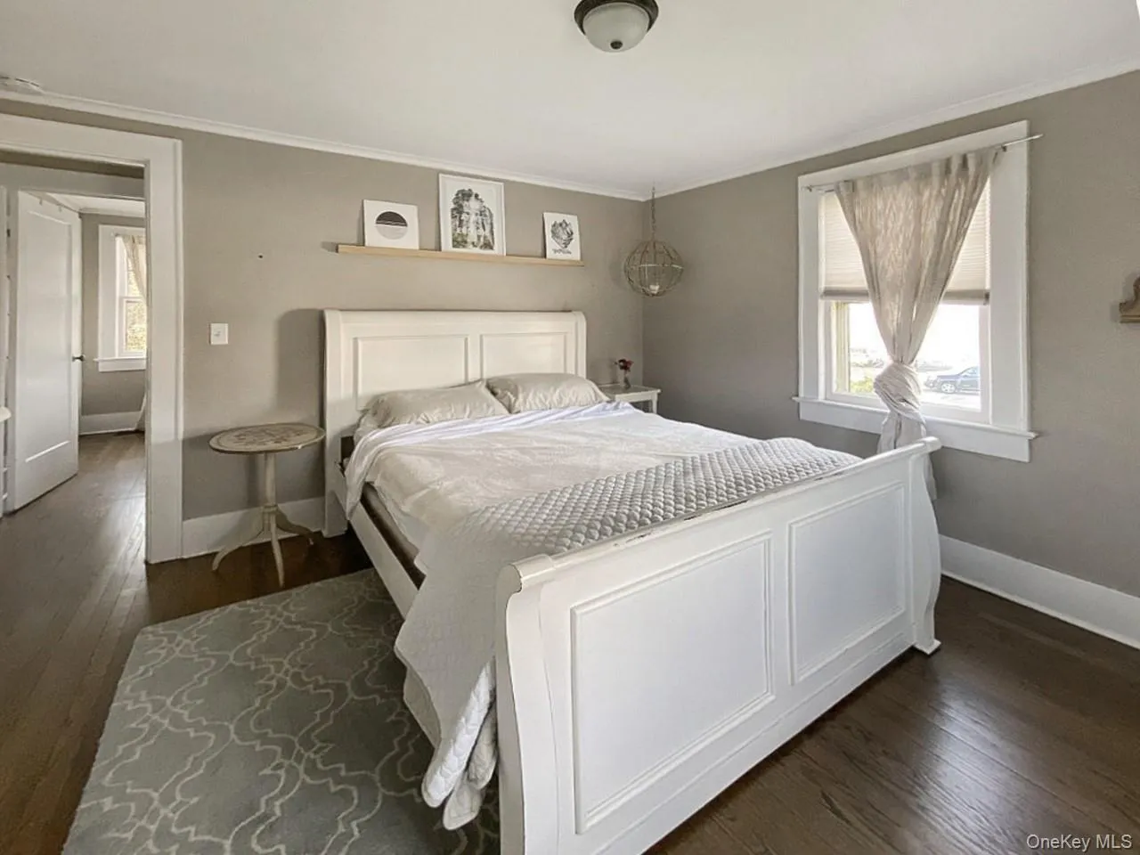Bedroom with dark wood-type flooring and ornamental molding Bedroom with dark wood-type flooring and ornamental molding