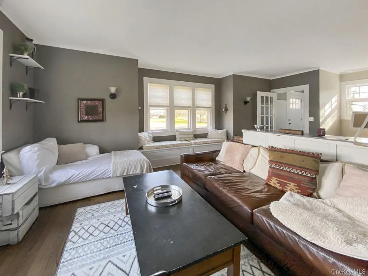 Living room featuring crown molding and wood finished floors Living room featuring crown molding and wood finished floors