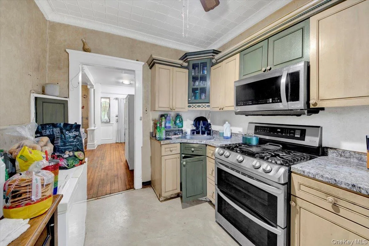 Kitchen with view of entry way in the background. Kitchen with view of entry way in the background.