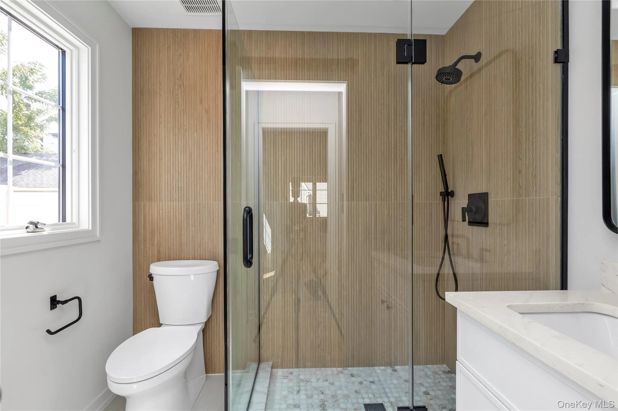 Full bathroom featuring a stall shower and vanity Full bathroom featuring a stall shower and vanity