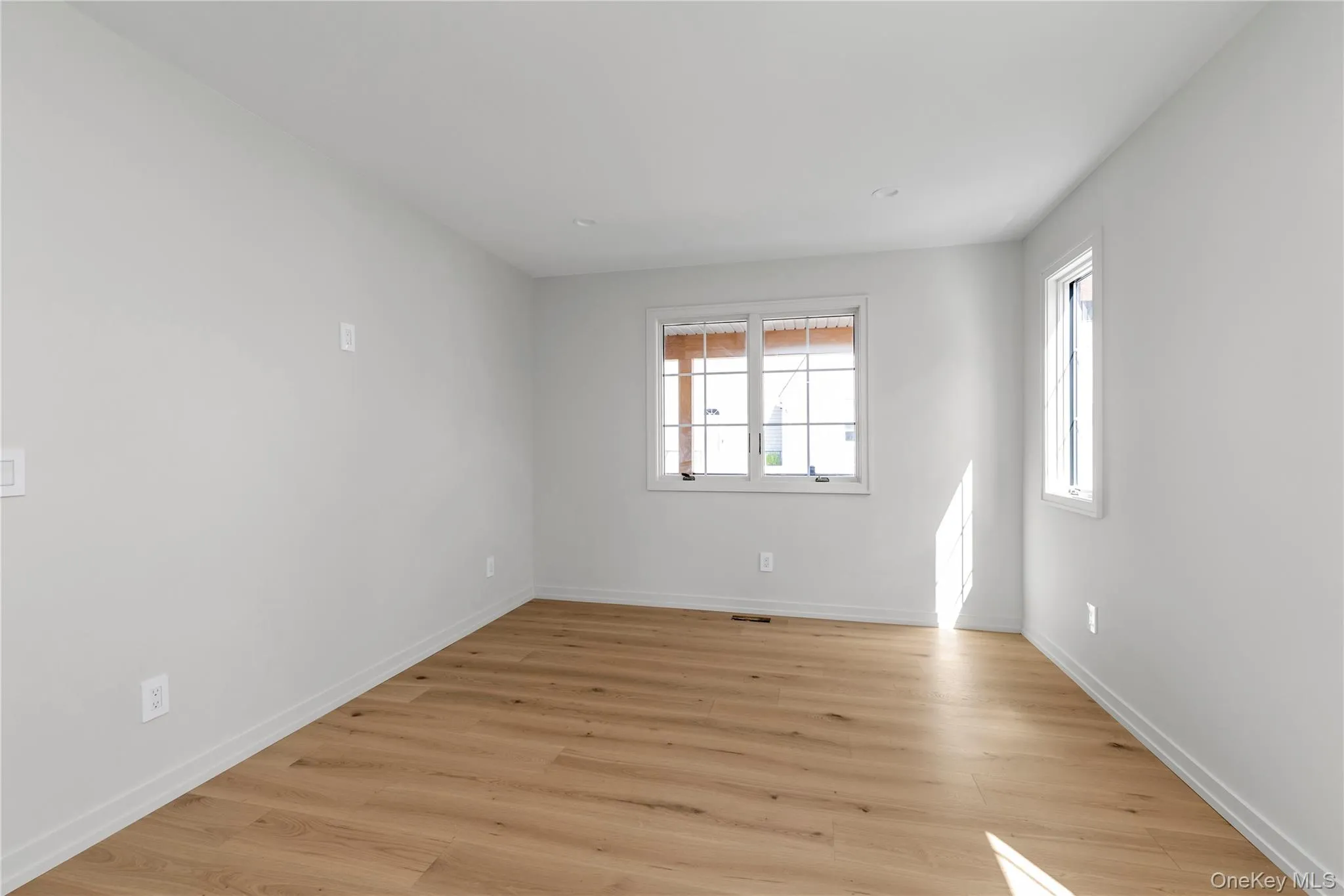 Unfurnished room featuring light wood-style floors Unfurnished room featuring light wood-style floors