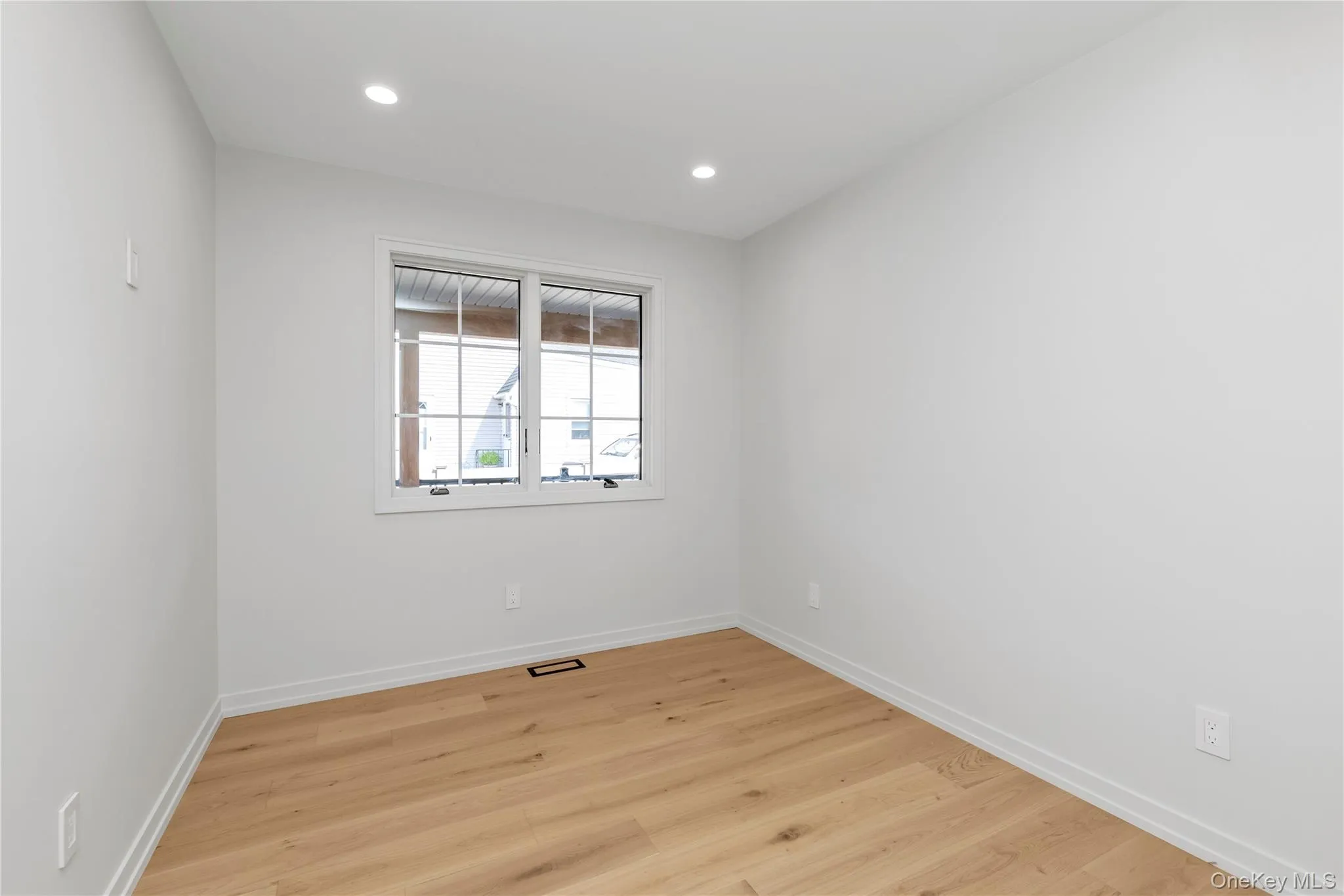 Unfurnished room featuring light wood-style floors and recessed lighting Unfurnished room featuring light wood-style floors and recessed lighting