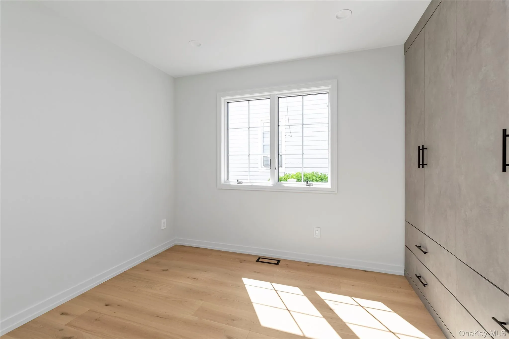 Unfurnished bedroom with light wood-style floors Unfurnished bedroom with light wood-style floors