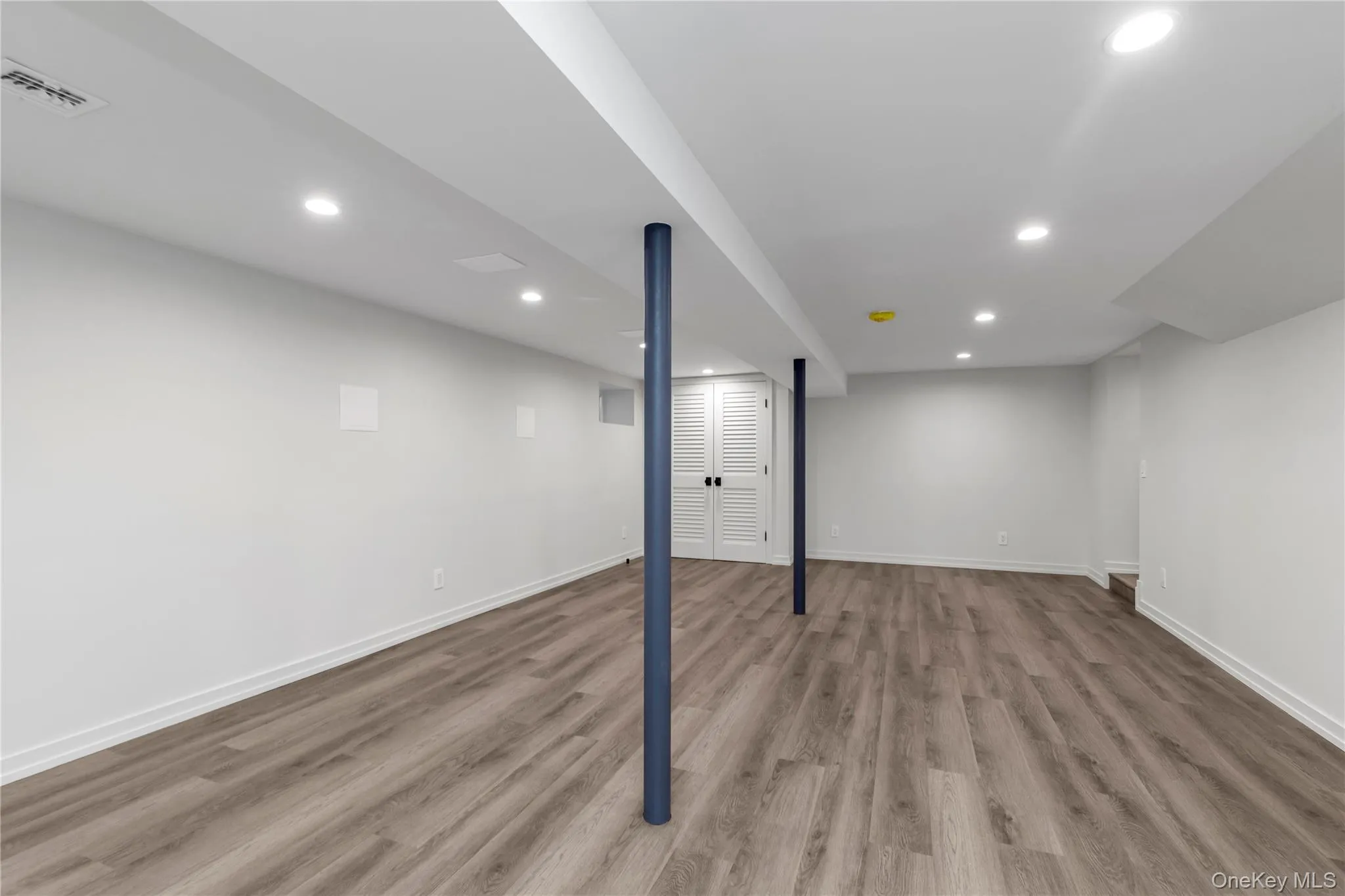 Finished basement featuring recessed lighting and light wood-type flooring Finished basement featuring recessed lighting and light wood-type flooring