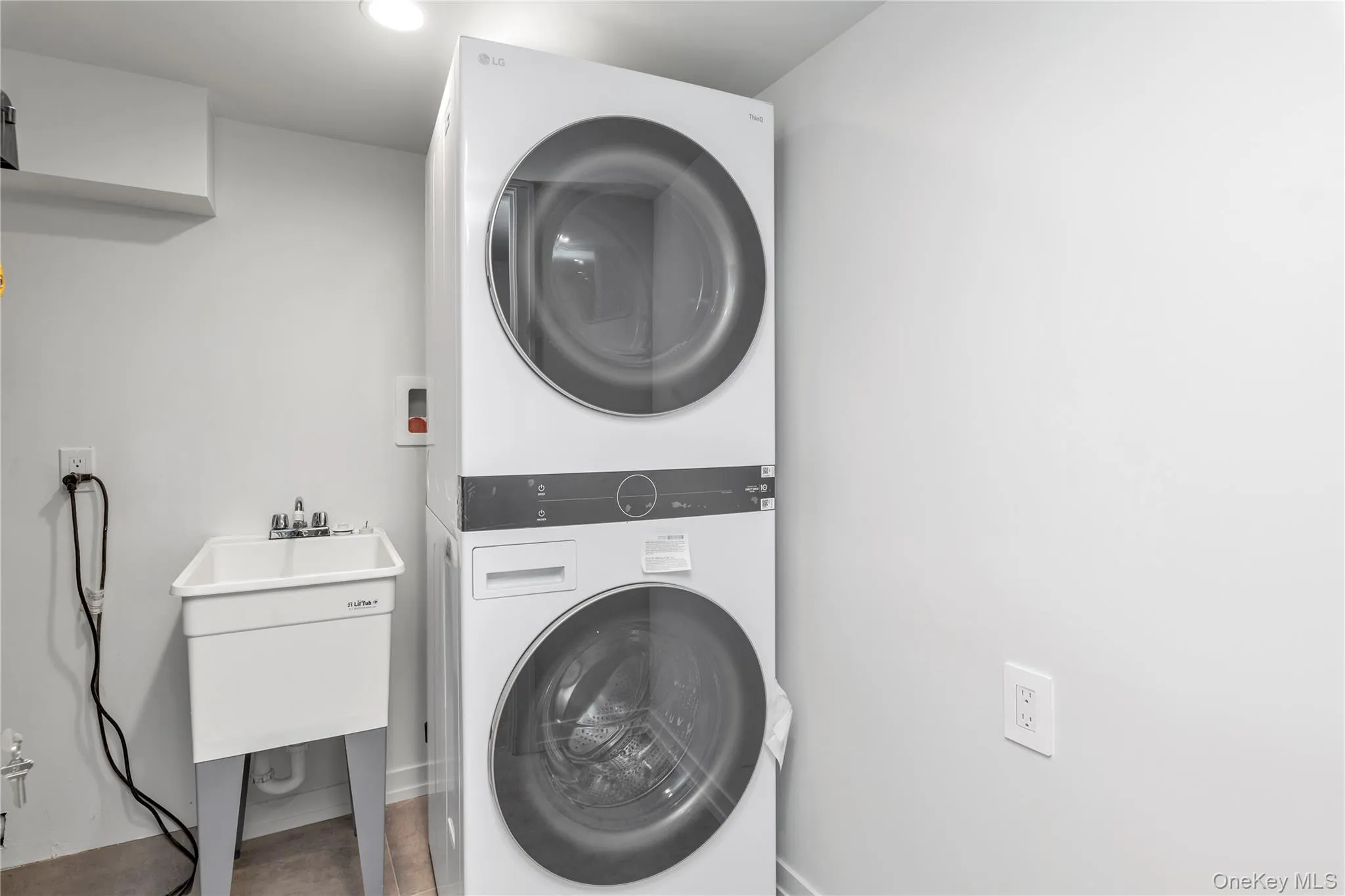Washroom featuring stacked washer and clothes dryer Washroom featuring stacked washer and clothes dryer