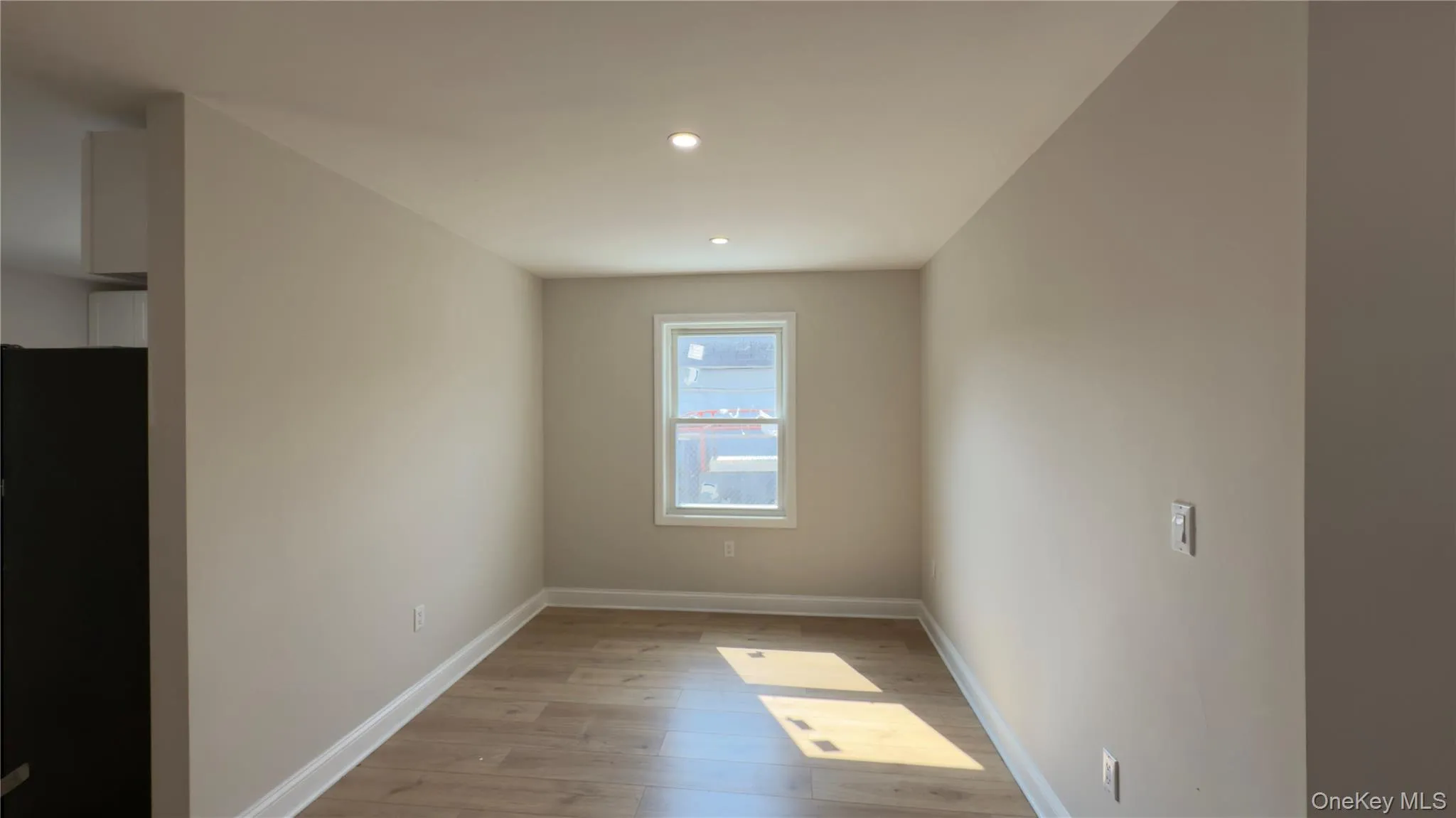 Empty room with light wood finished floors and recessed lighting Empty room with light wood finished floors and recessed lighting