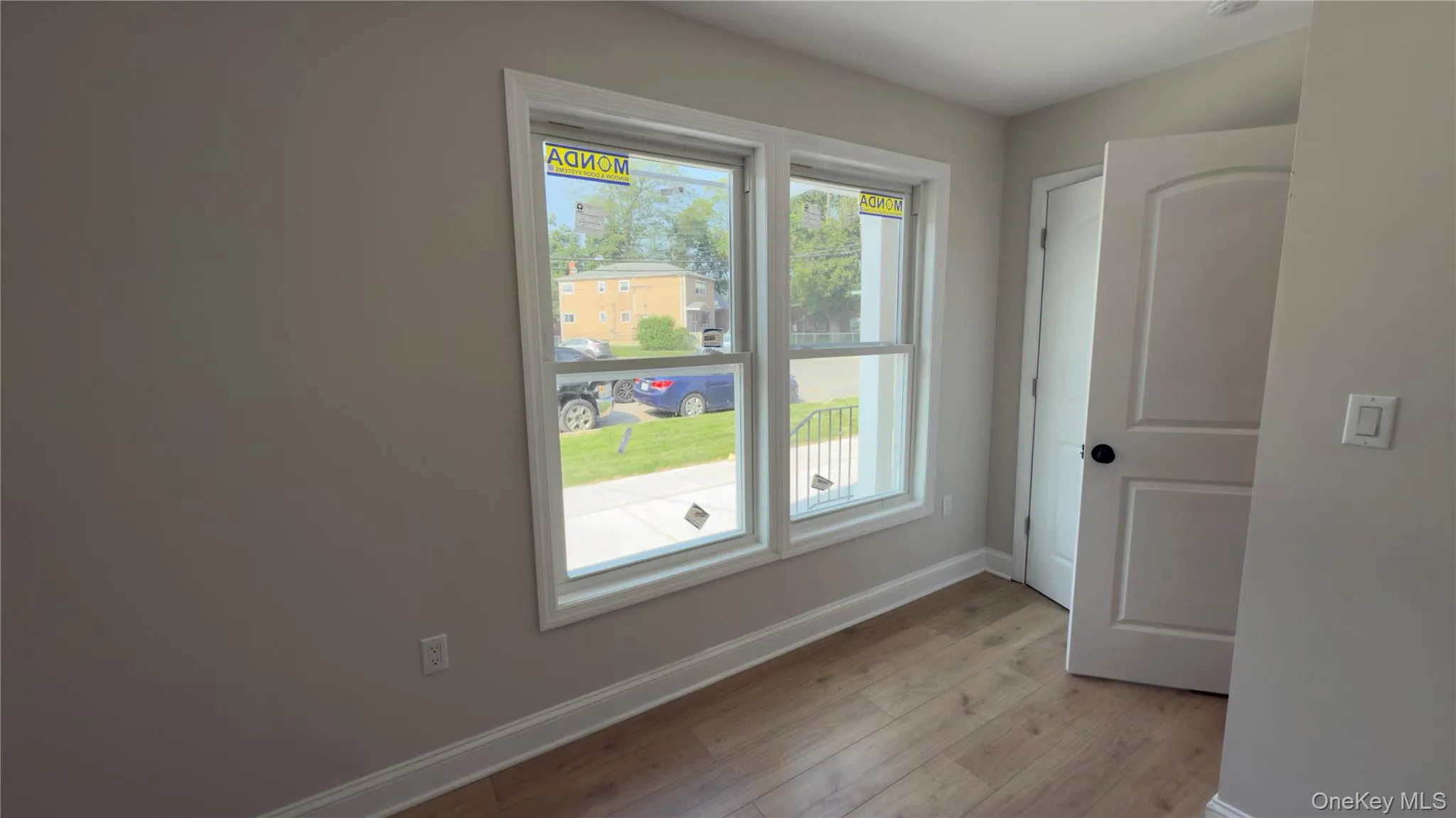 Unfurnished room with baseboards and light wood-style floors Unfurnished room with baseboards and light wood-style floors