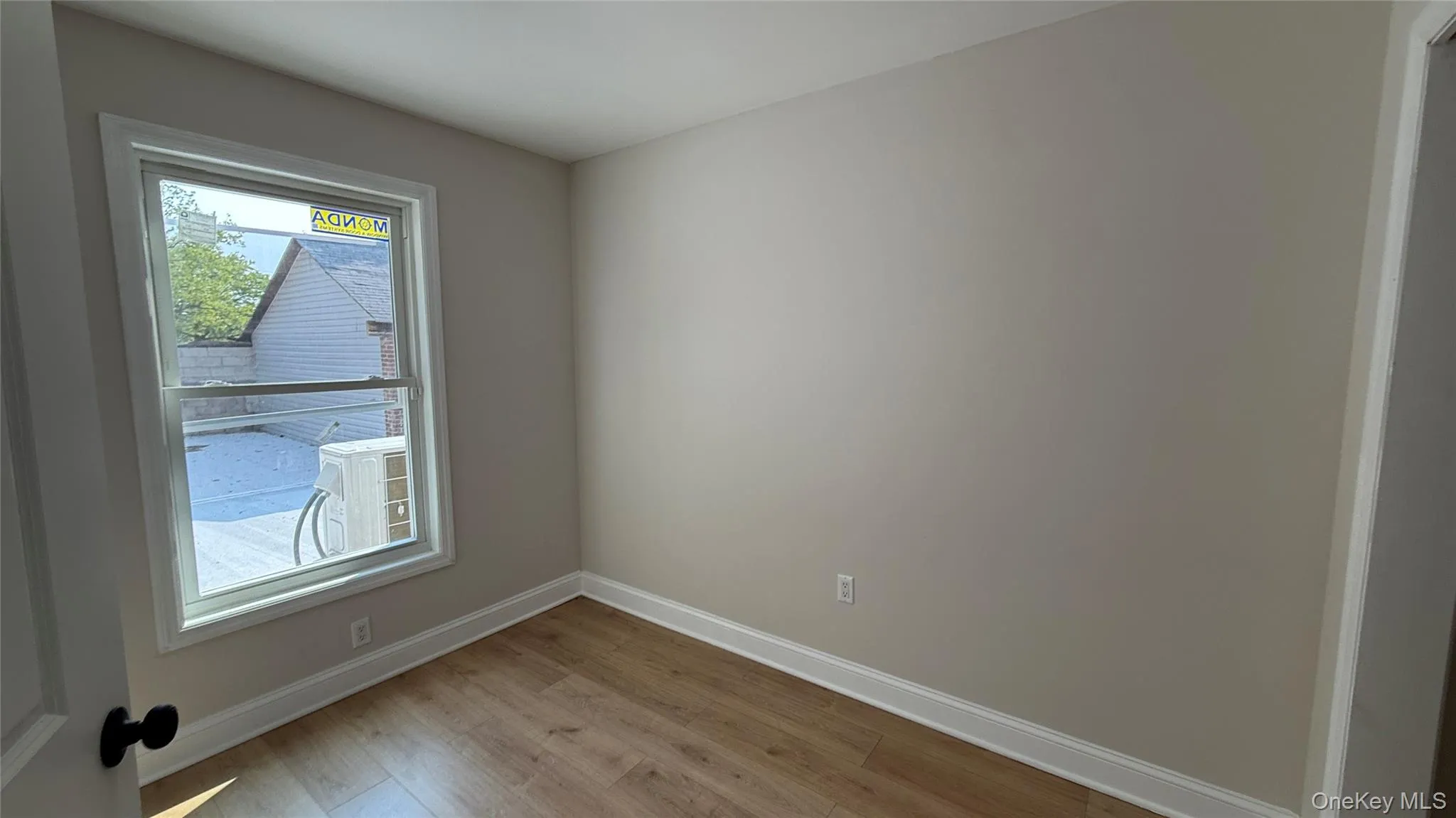 Empty room with light wood-style floors and baseboards Empty room with light wood-style floors and baseboards