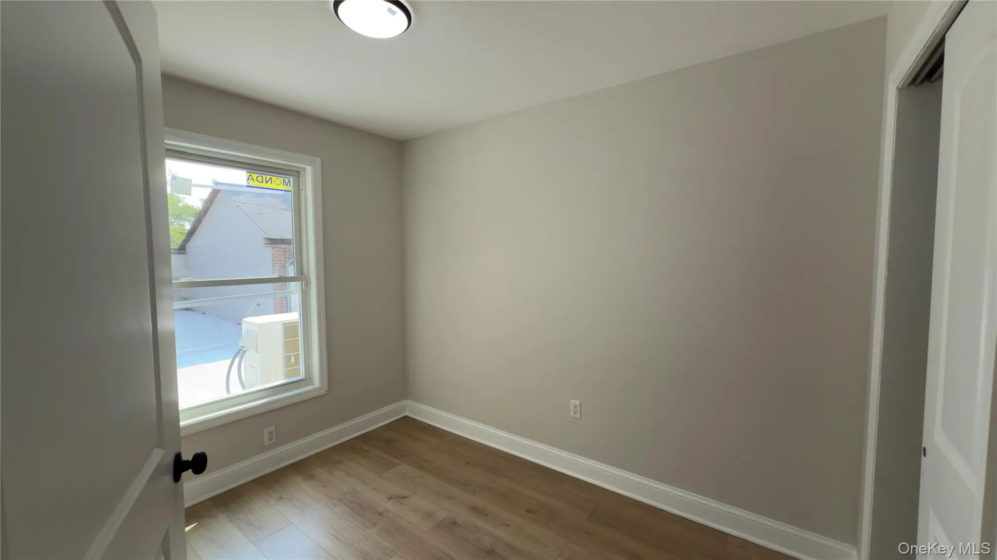 Empty room with light wood-type flooring and baseboards Empty room with light wood-type flooring and baseboards