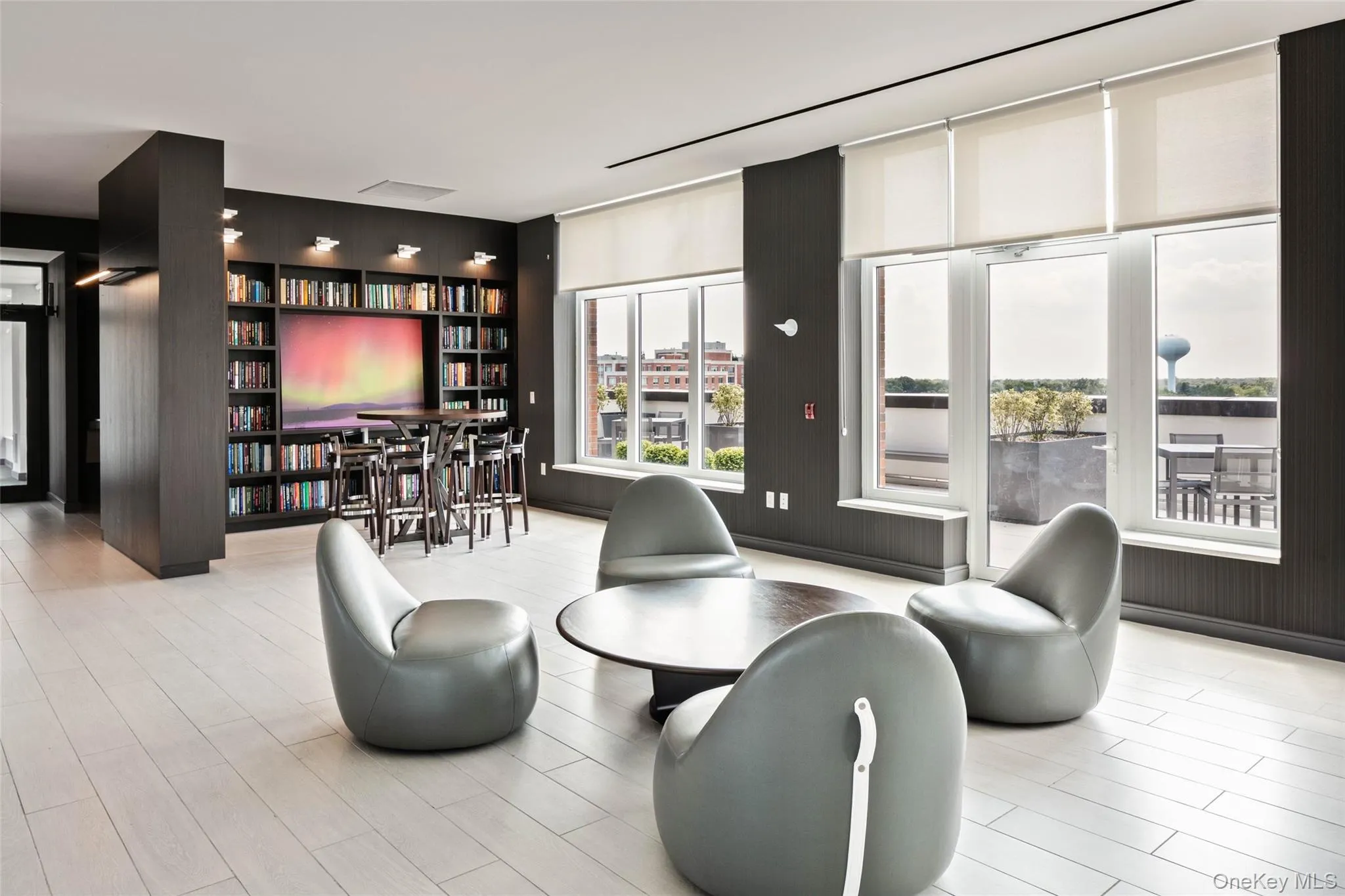Living area with healthy amount of natural light, floor to ceiling windows, and a stone fireplace Living area with healthy amount of natural light, floor to ceiling windows, and a stone fireplace