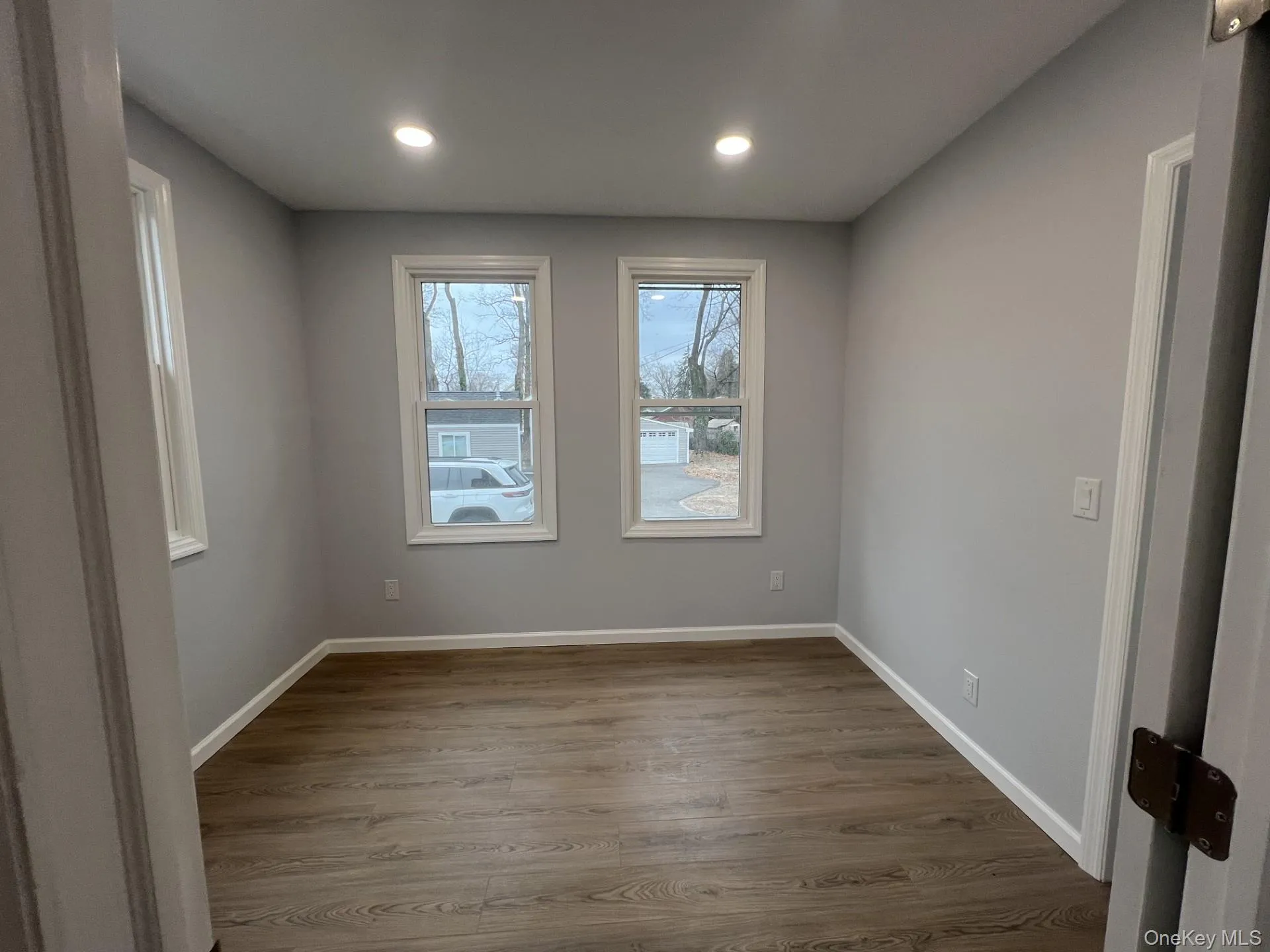 Spare room with dark wood finished floors and recessed lighting Spare room with dark wood finished floors and recessed lighting