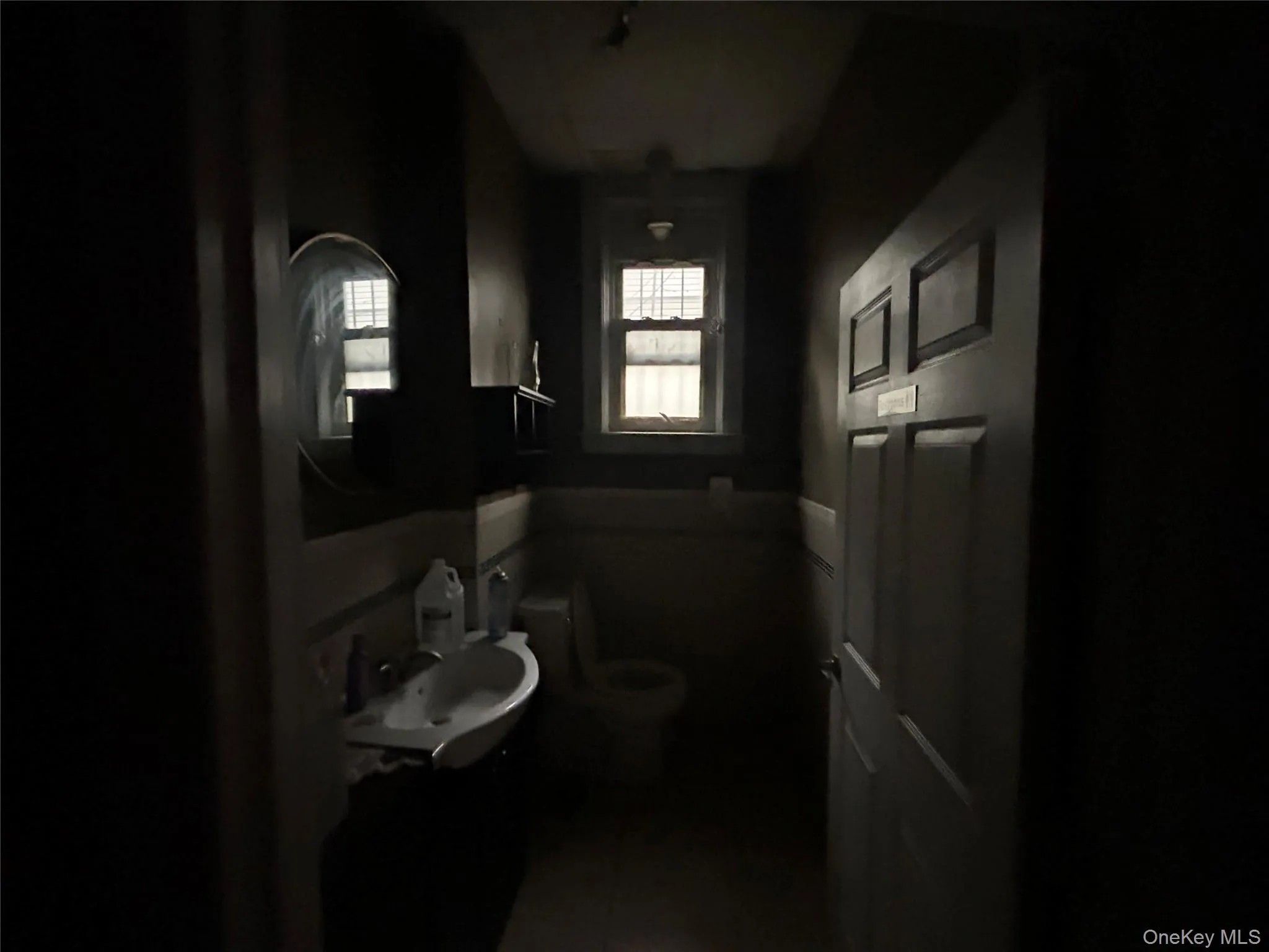 Half bathroom with a sink and tile patterned floors Half bathroom with a sink and tile patterned floors