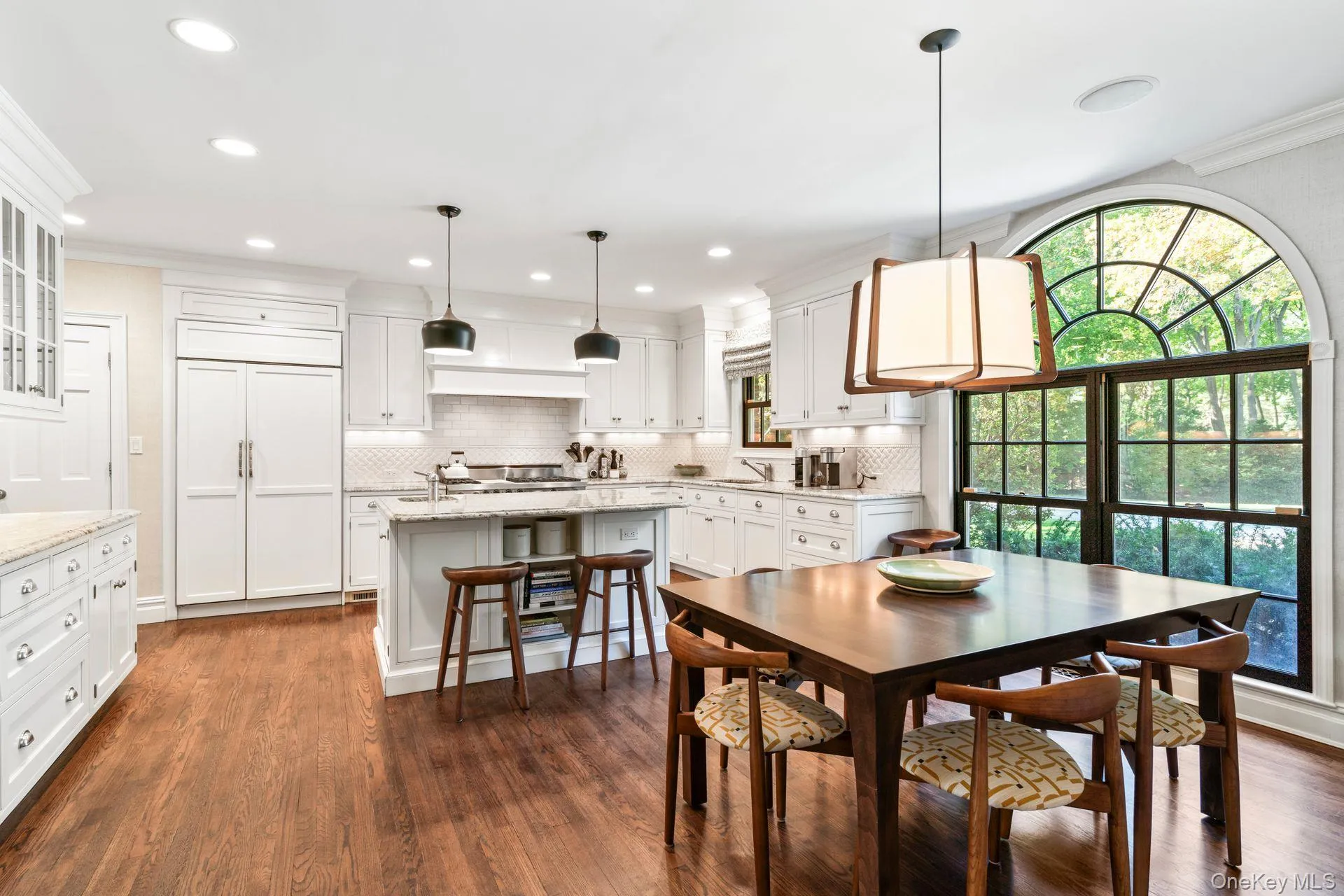 Dining area featuring dark wood-type flooring, recessed lighting, and ornamental molding Dining area featuring dark wood-type flooring, recessed lighting, and ornamental molding