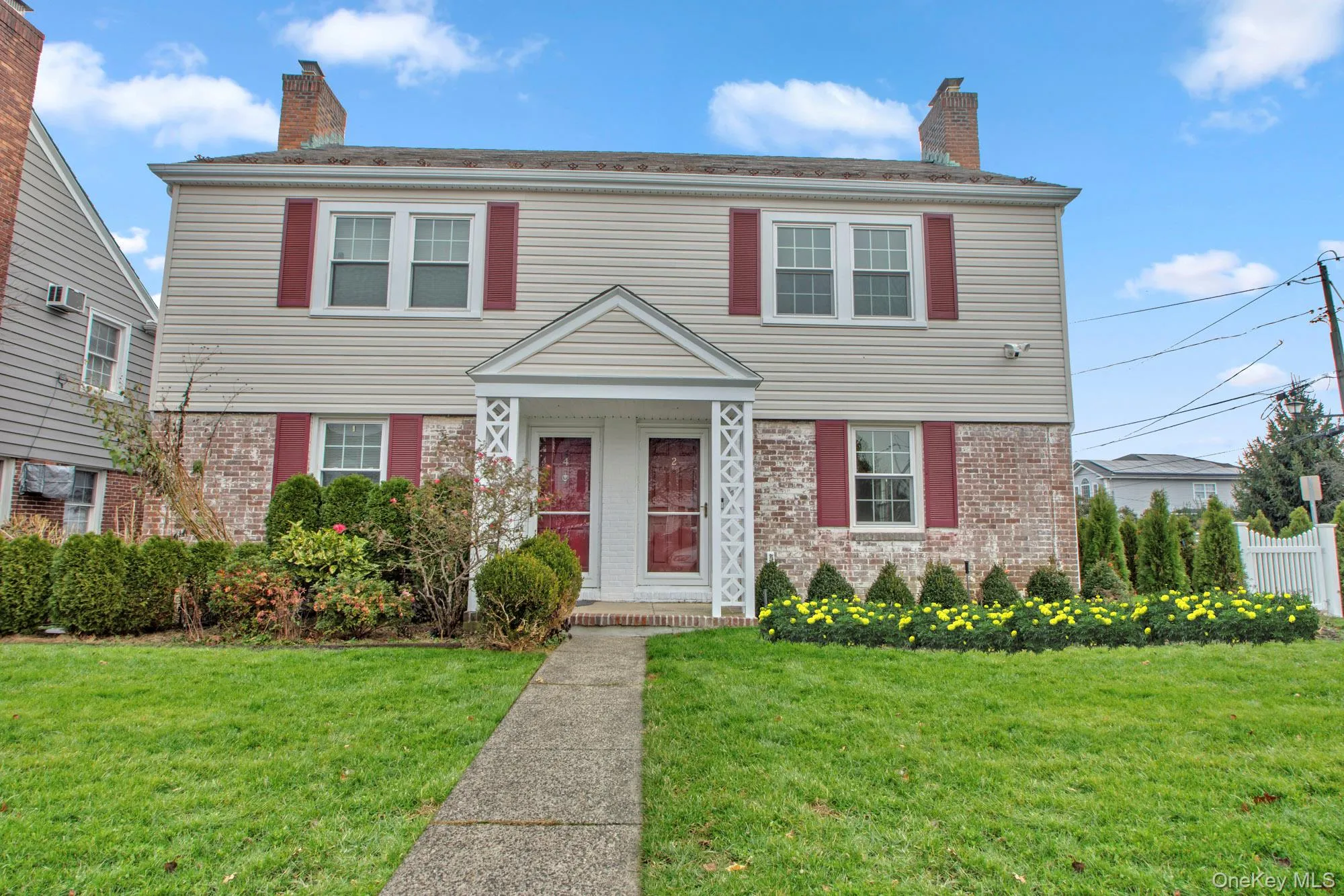 Colonial inspired home with brick siding and a chimney Colonial inspired home with brick siding and a chimney