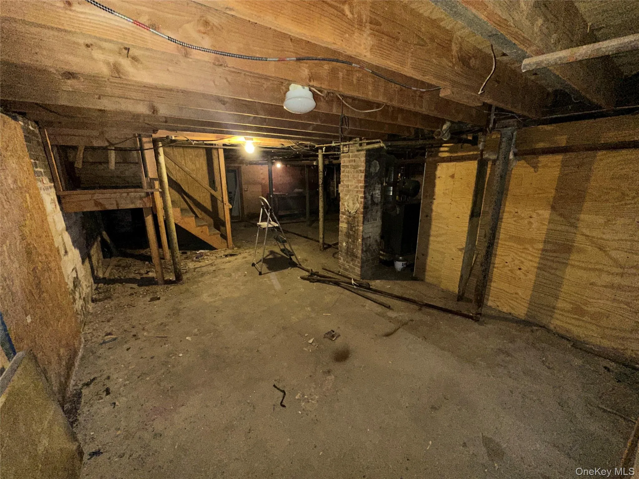 Unfinished basement featuring stairs Unfinished basement featuring stairs