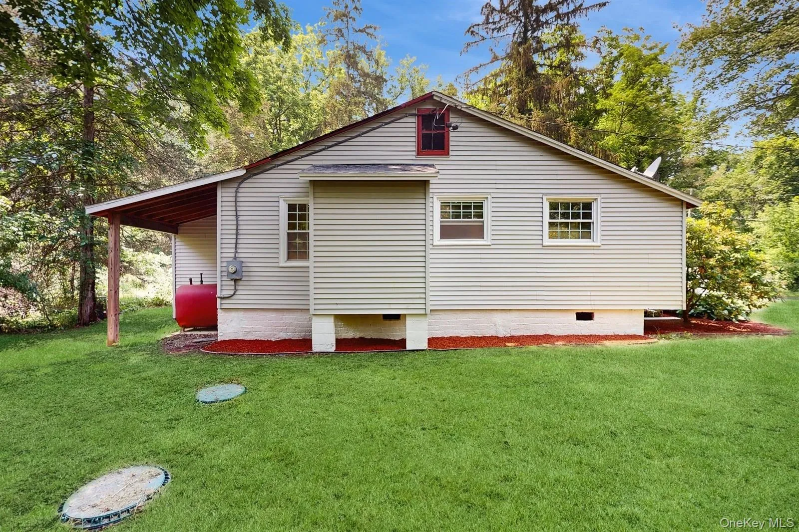 View of side of home featuring crawl space, a lawn, and oil tank View of side of home featuring crawl space, a lawn, and oil tank