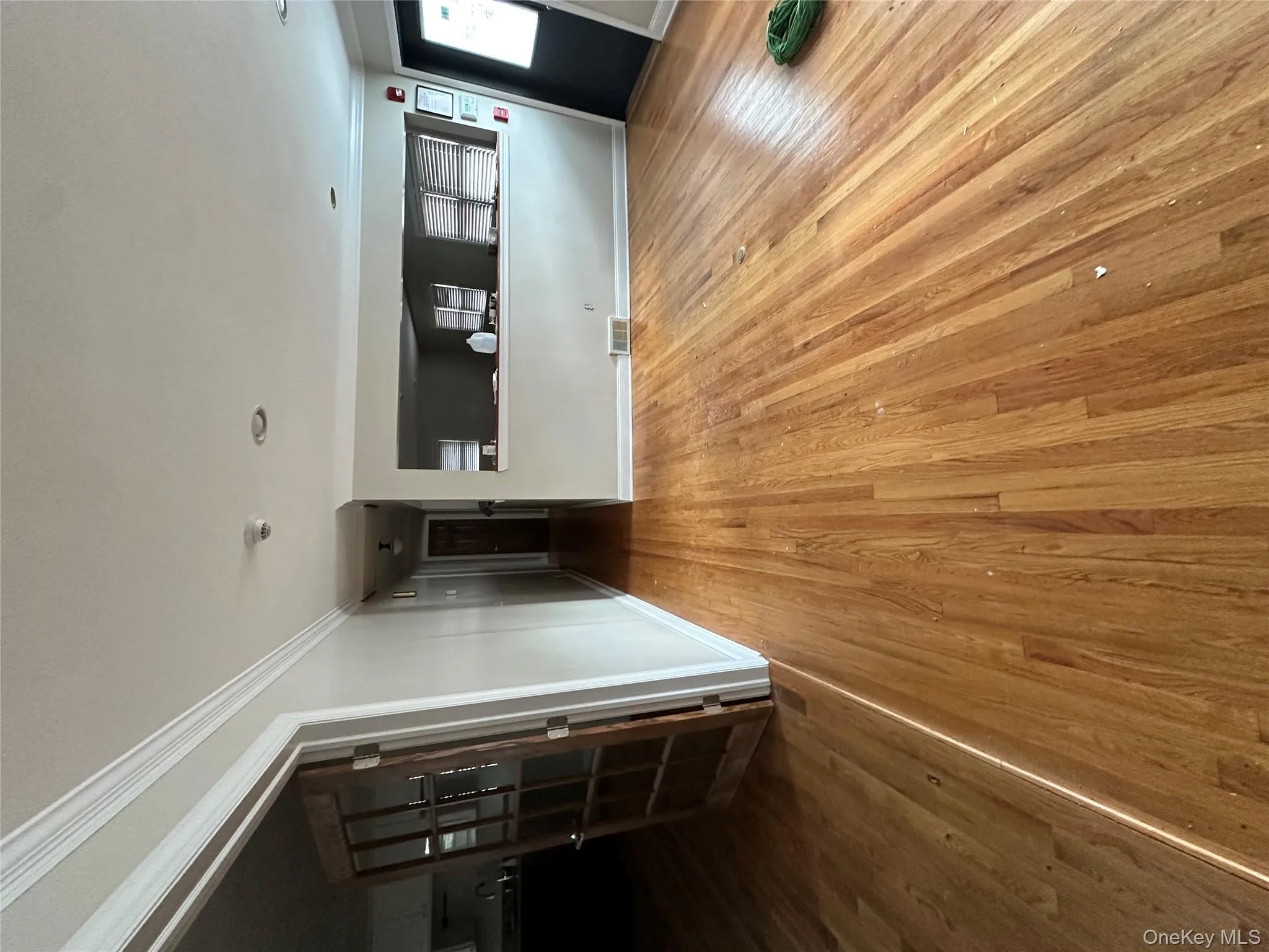 Unfurnished living room featuring crown molding and light wood-style flooring Unfurnished living room featuring crown molding and light wood-style flooring