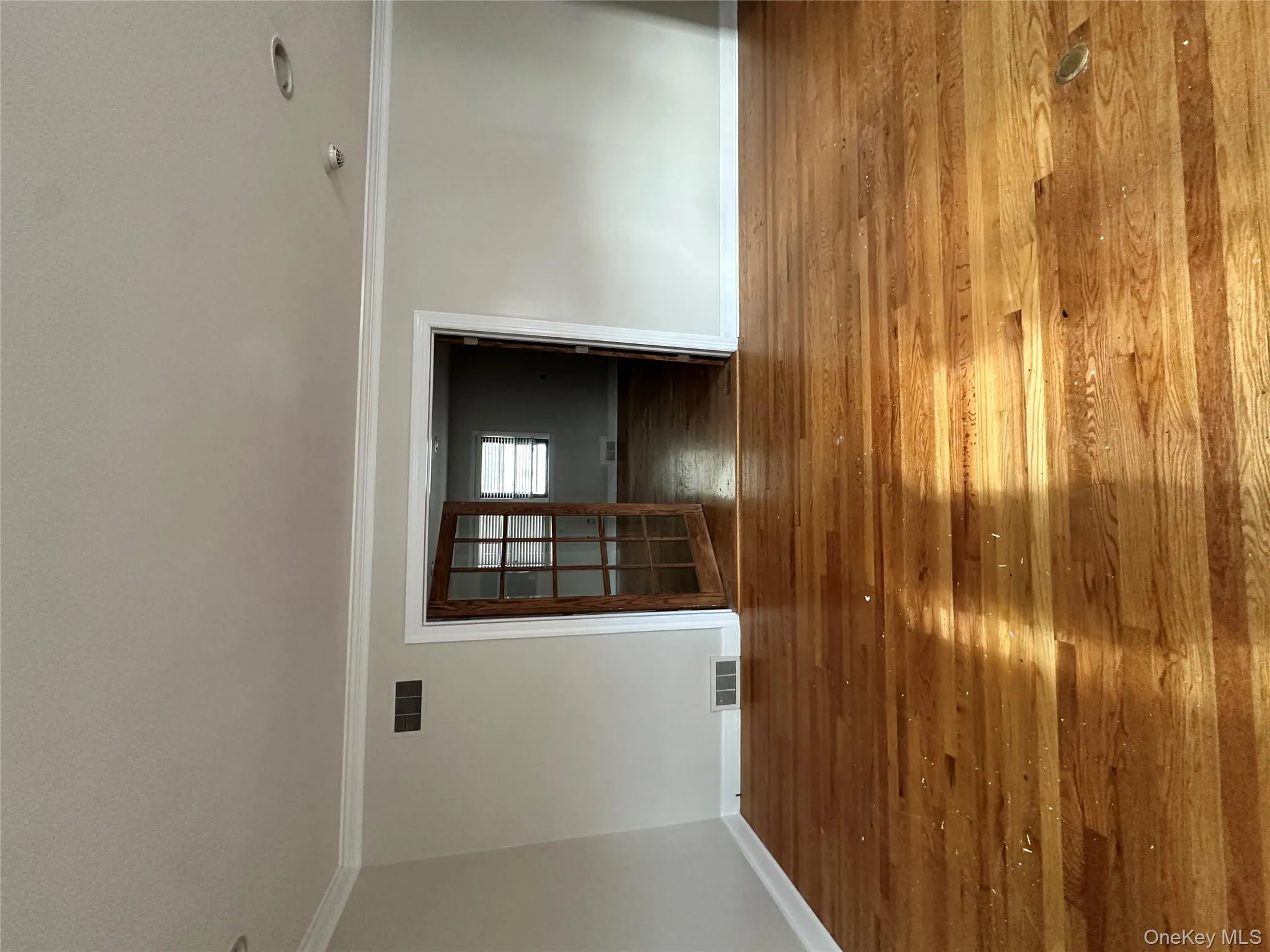 Unfurnished room featuring hardwood / wood-style floors and crown molding Unfurnished room featuring hardwood / wood-style floors and crown molding