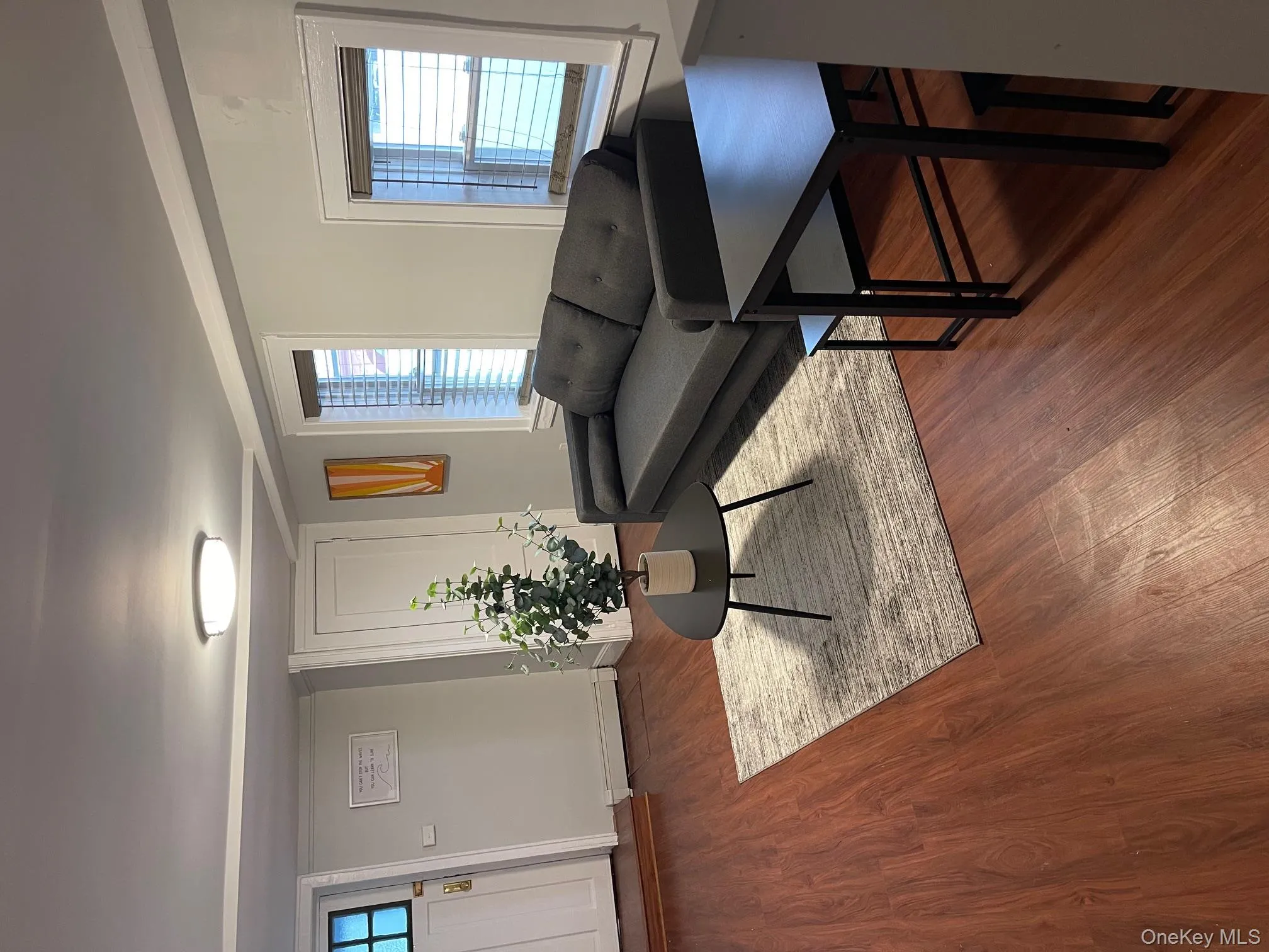 Living room featuring wood finished floors and baseboard heating Living room featuring wood finished floors and baseboard heating