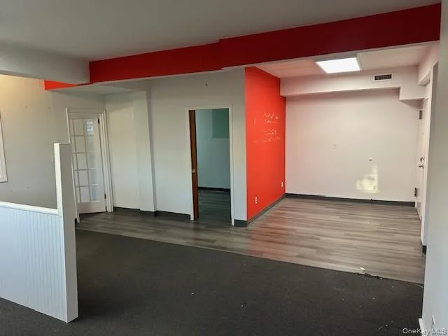 Spare room featuring dark wood finished floors Spare room featuring dark wood finished floors