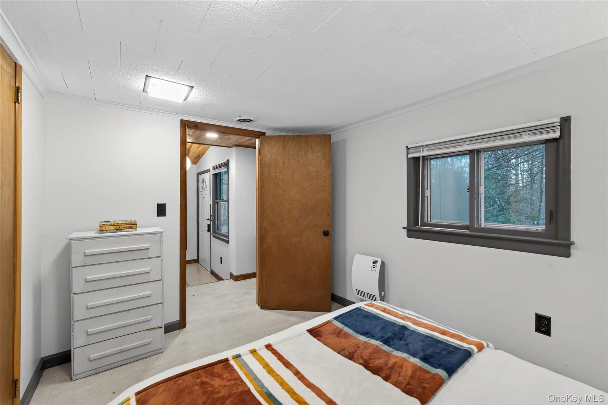 Bedroom featuring heating unit and baseboards Bedroom featuring heating unit and baseboards