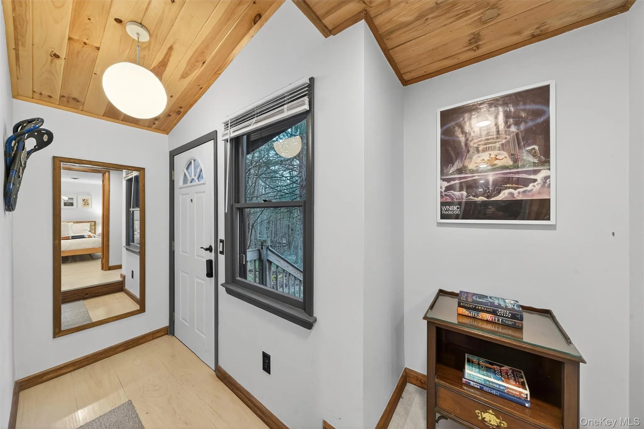 Entrance foyer with lofted ceiling, light wood-style floors, and wooden ceiling Entrance foyer with lofted ceiling, light wood-style floors, and wooden ceiling