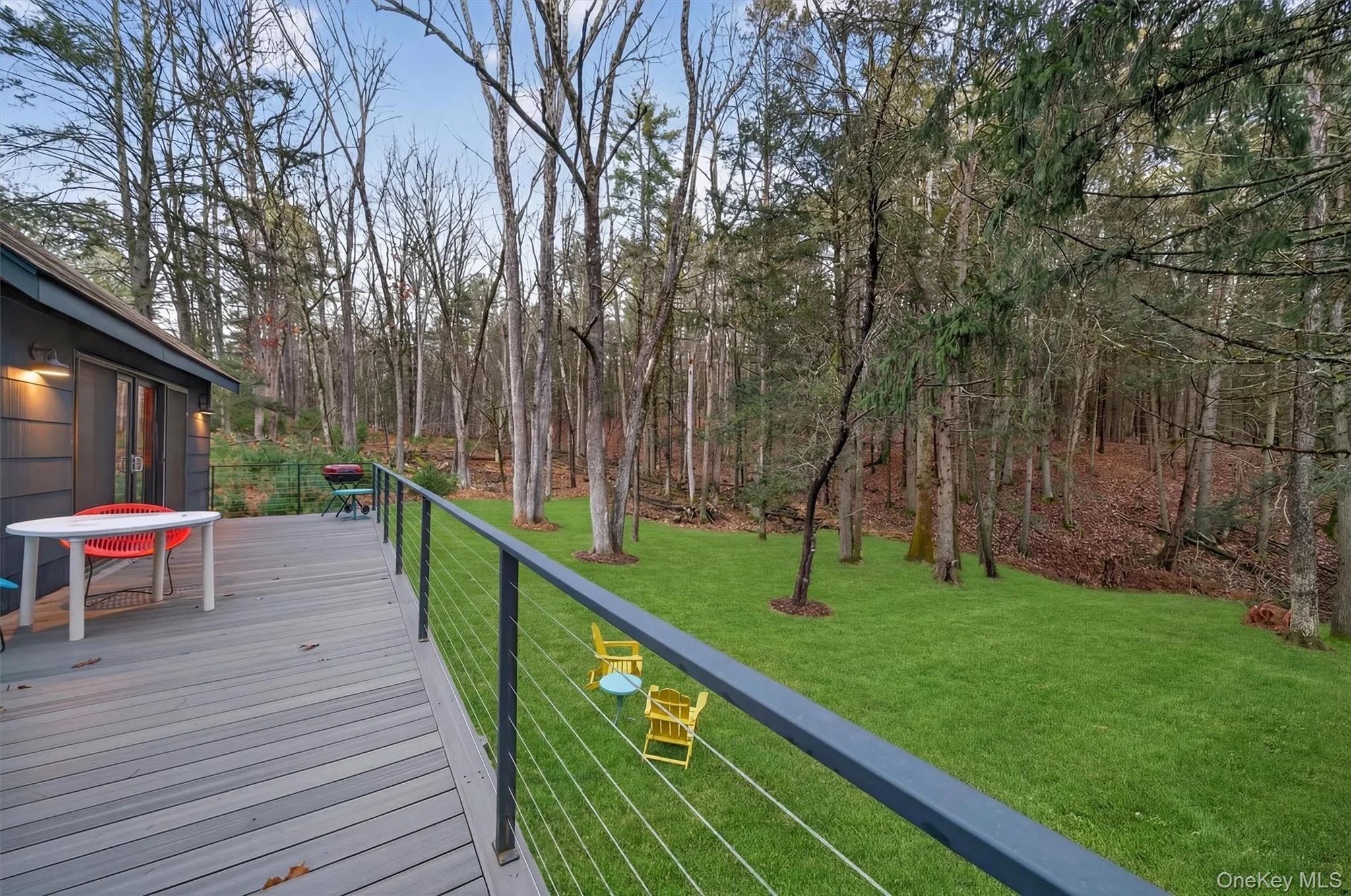 Wooden terrace featuring a lawn Wooden terrace featuring a lawn
