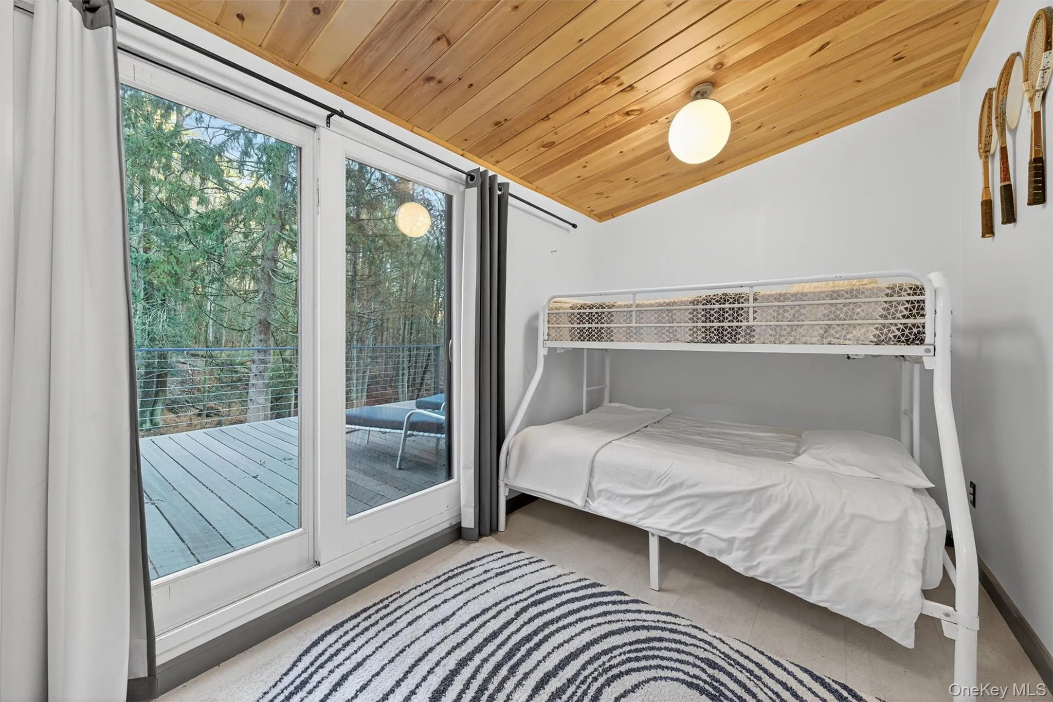 Bedroom featuring lofted ceiling, wooden ceiling, and access to outside Bedroom featuring lofted ceiling, wooden ceiling, and access to outside