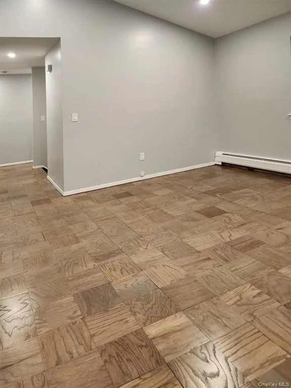 Unfurnished room with baseboards and baseboard heating Unfurnished room with baseboards and baseboard heating