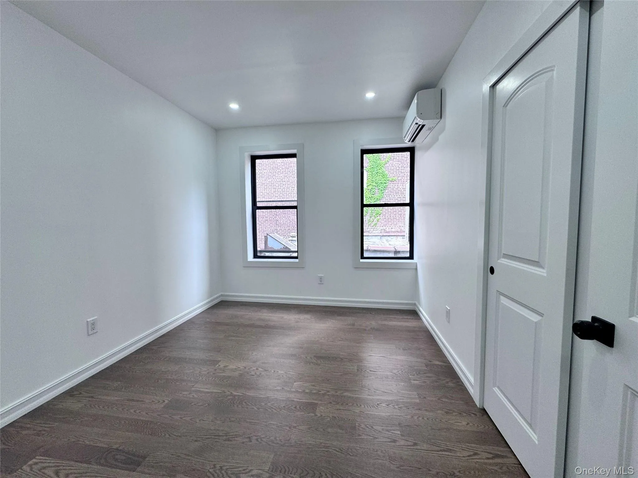 Spare room featuring dark wood-style floors and recessed lighting Spare room featuring dark wood-style floors and recessed lighting