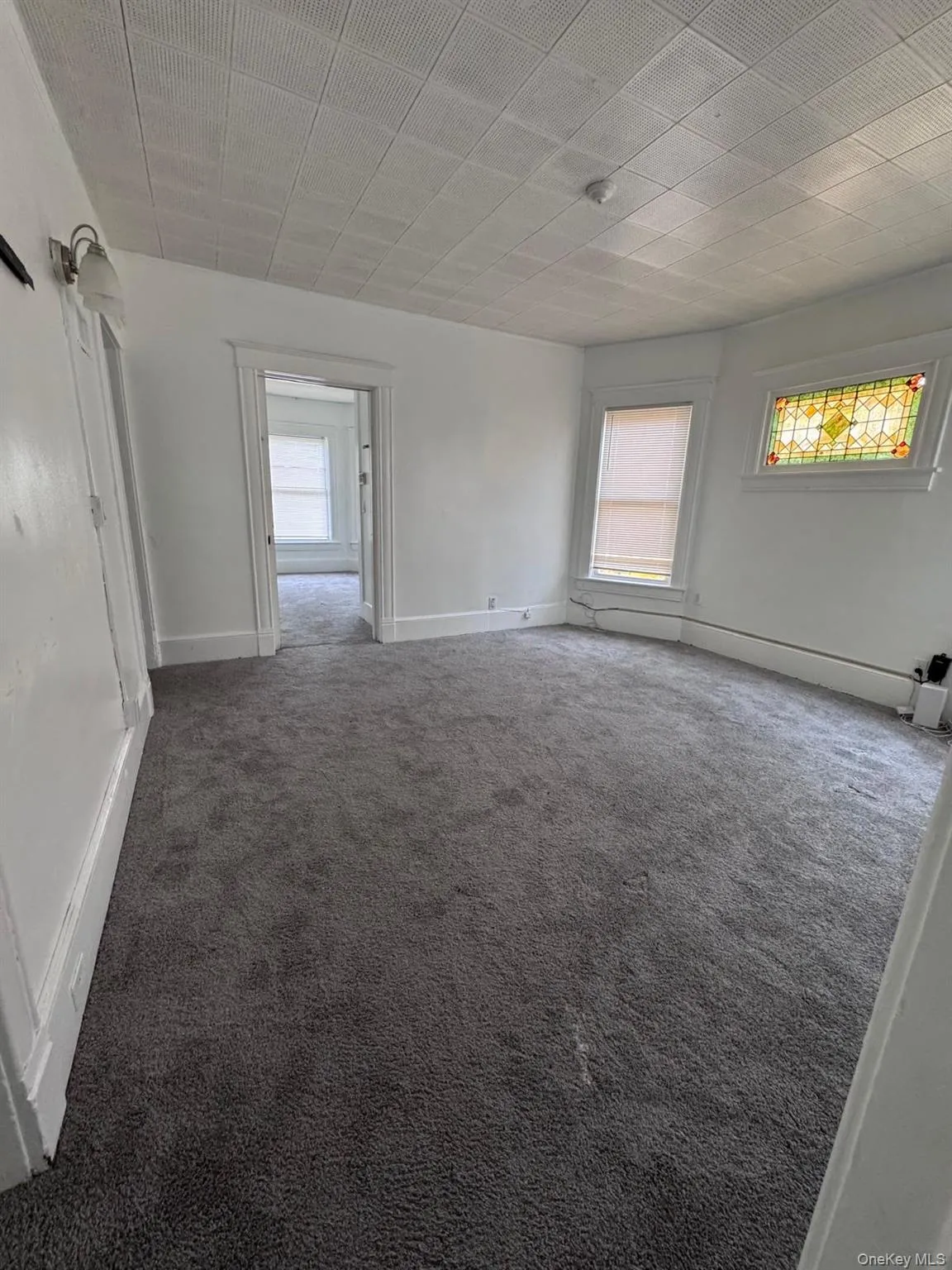 Spare room featuring carpet flooring Spare room featuring carpet flooring