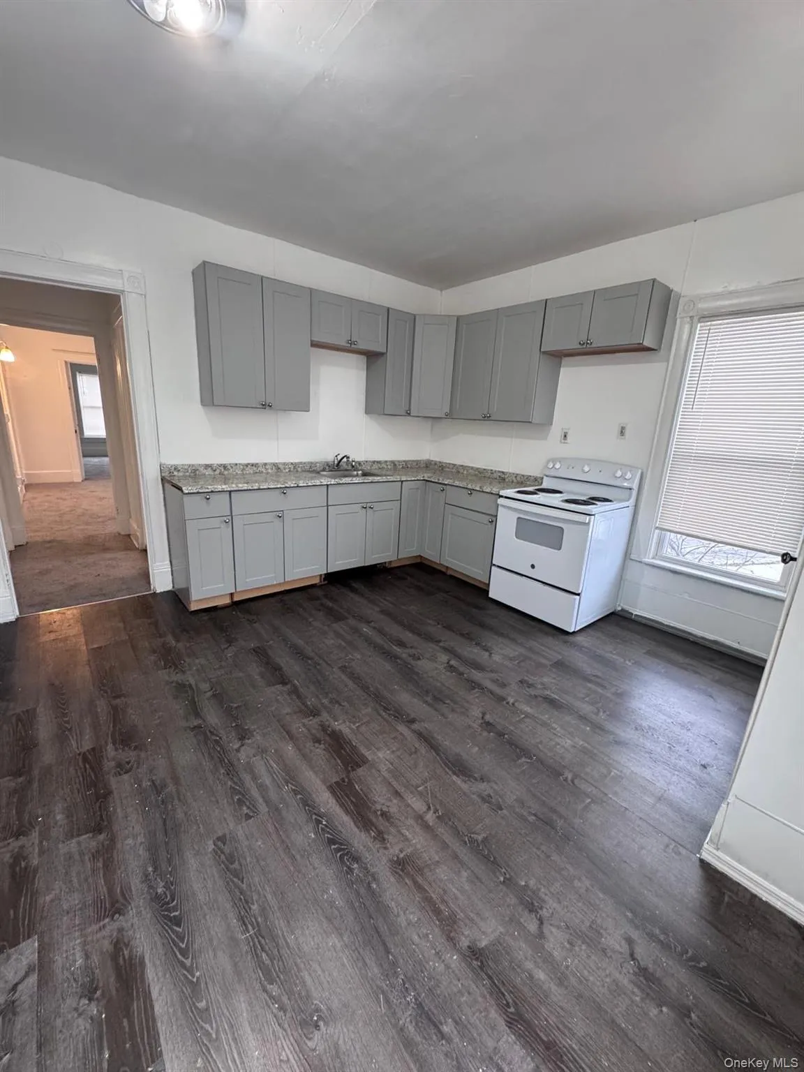 Kitchen with electric range, gray cabinetry, and dark wood-style flooring Kitchen with electric range, gray cabinetry, and dark wood-style flooring