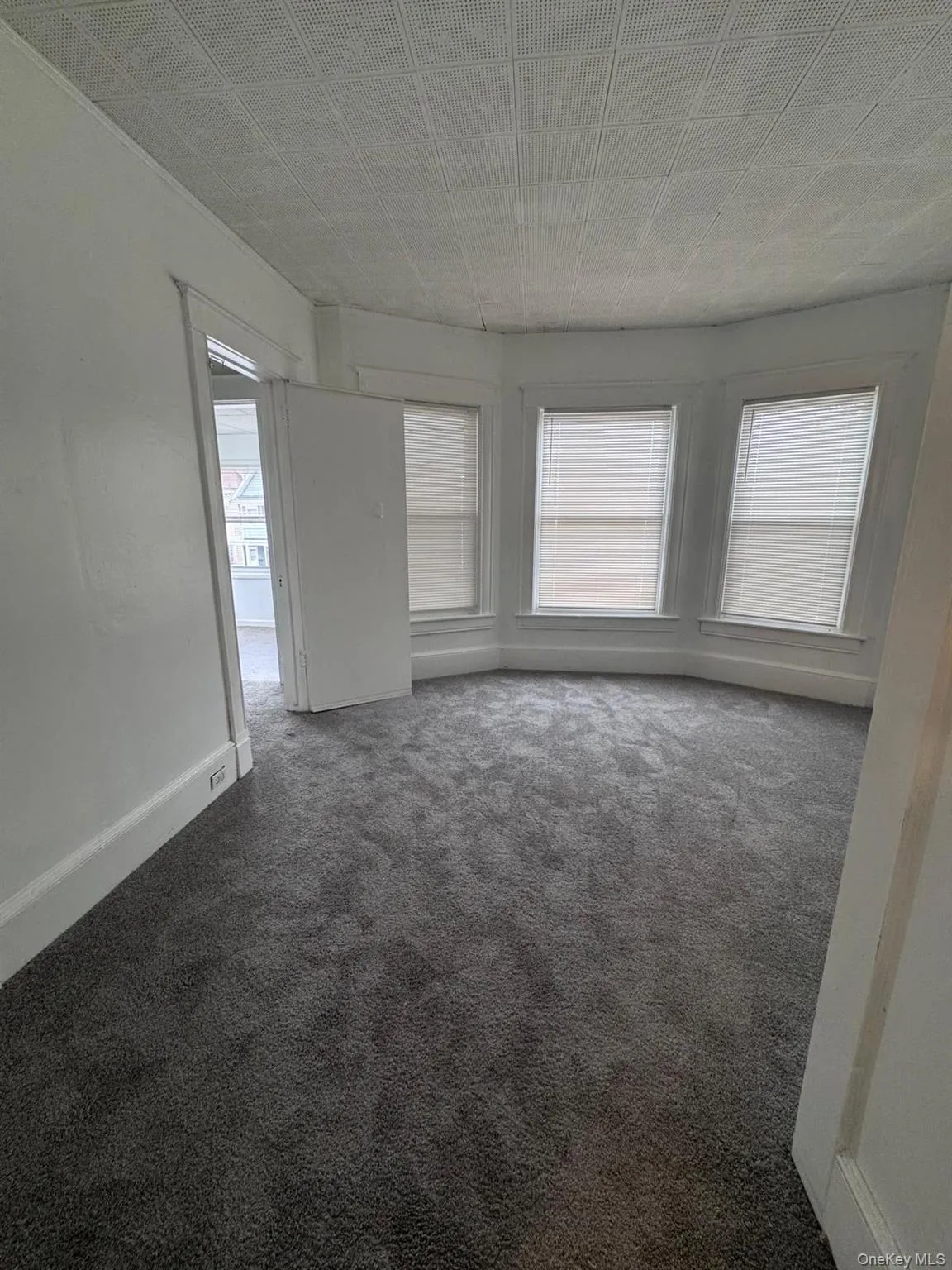 Unfurnished room with carpet floors and baseboards Unfurnished room with carpet floors and baseboards