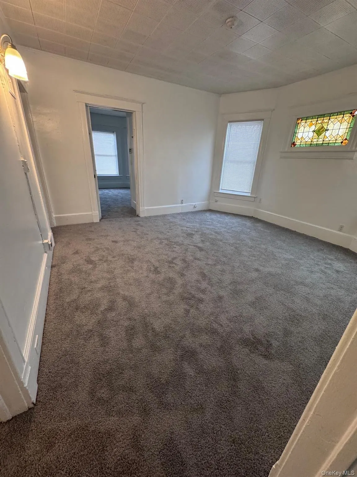 Empty room with baseboards and carpet flooring Empty room with baseboards and carpet flooring