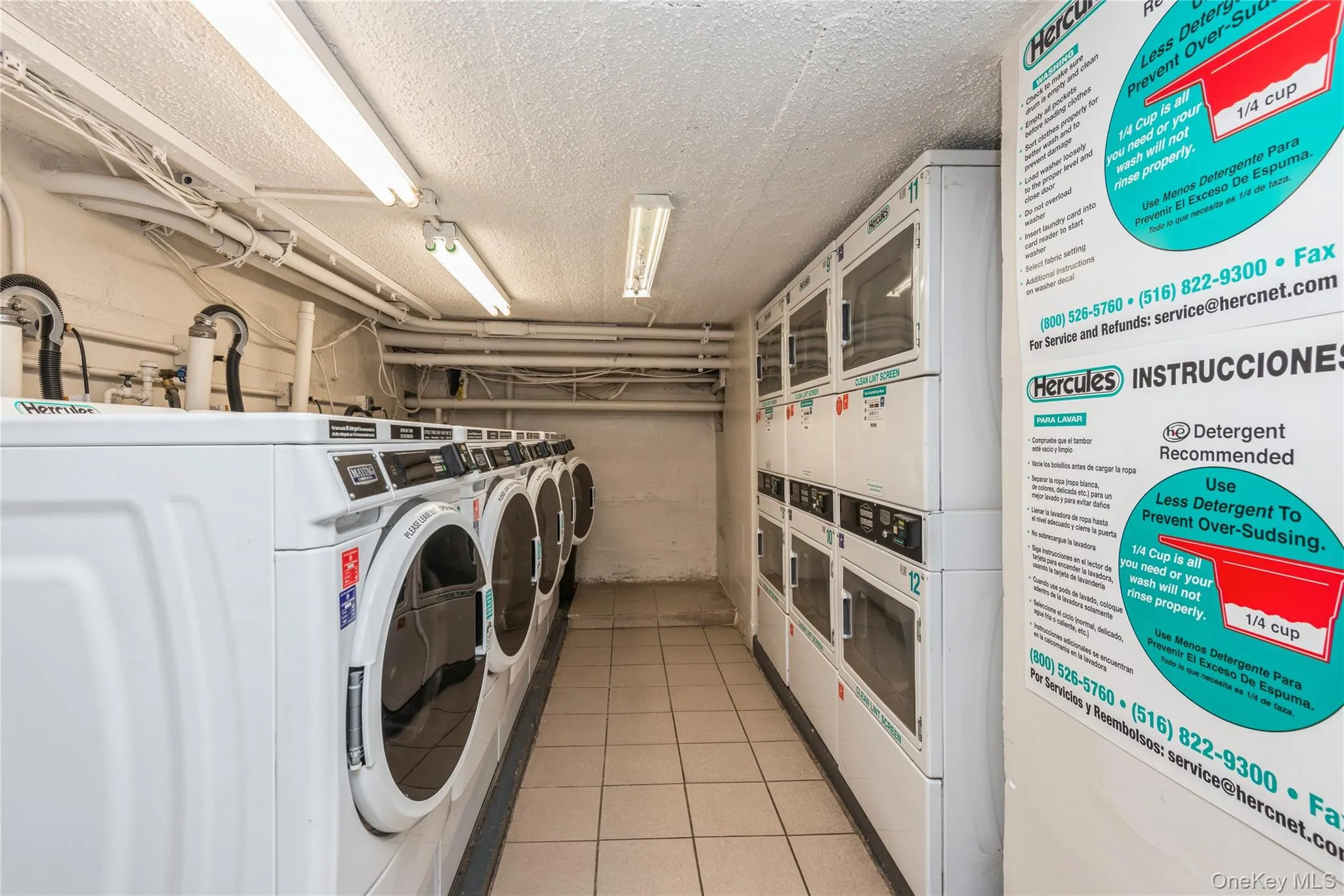 Community laundry room featuring estacked washer and dryer and a textured ceiling Community laundry room featuring estacked washer and dryer and a textured ceiling