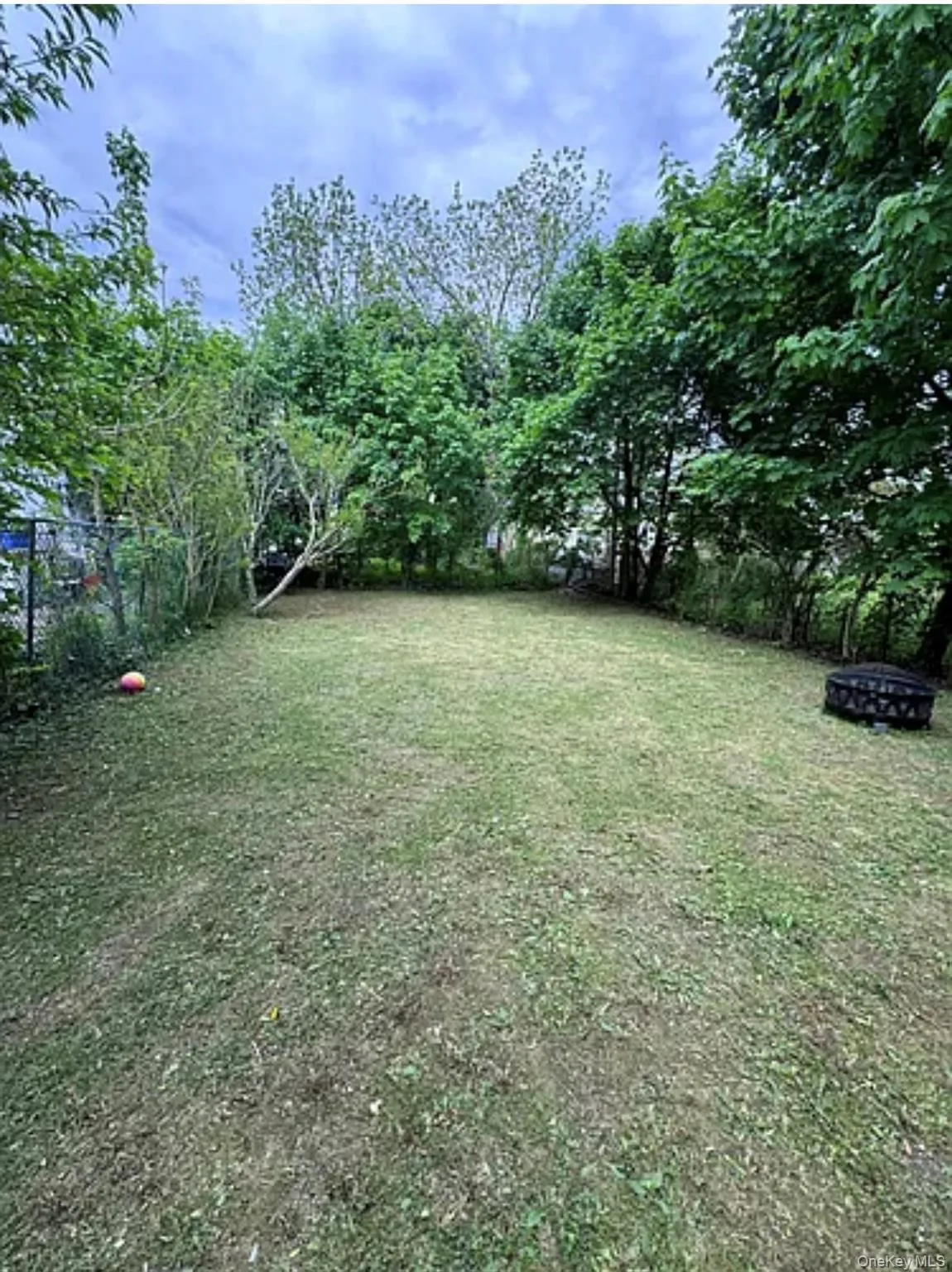 View of yard featuring a fire pit View of yard featuring a fire pit