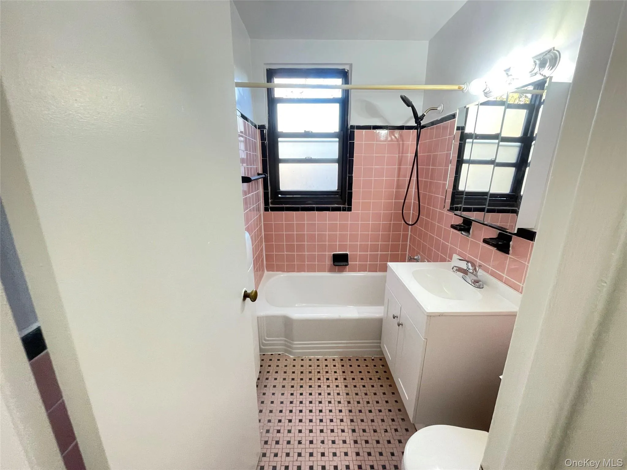 Bathroom with vanity, shower / washtub combination, and light flooring Bathroom with vanity, shower / washtub combination, and light flooring