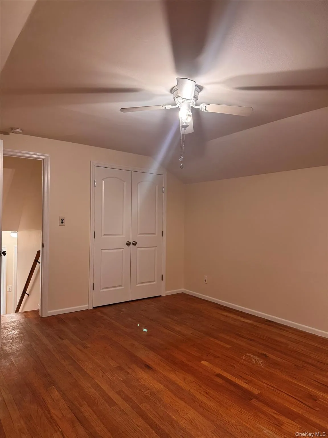 Bonus room featuring vaulted ceiling, dark wood-type flooring, and ceiling fan Bonus room featuring vaulted ceiling, dark wood-type flooring, and ceiling fan