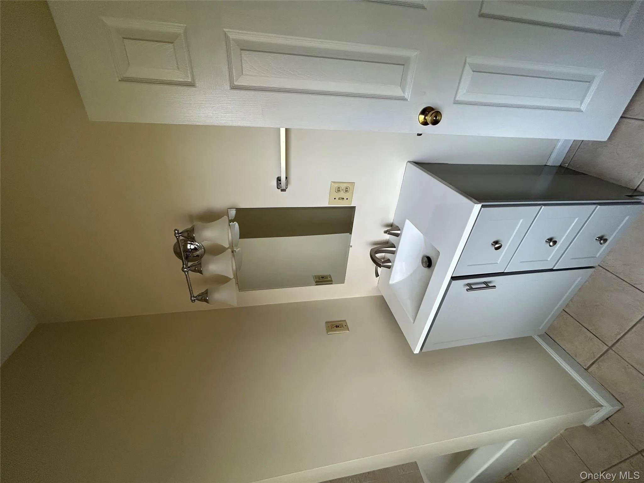 Bathroom with vanity and light tile patterned flooring Bathroom with vanity and light tile patterned flooring